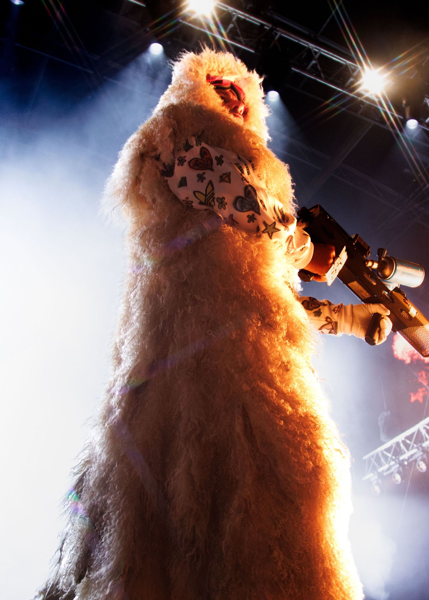 A large hairy Wampa creature from Star Wars illuminated dramatically on stage with theatrical lighting effects.