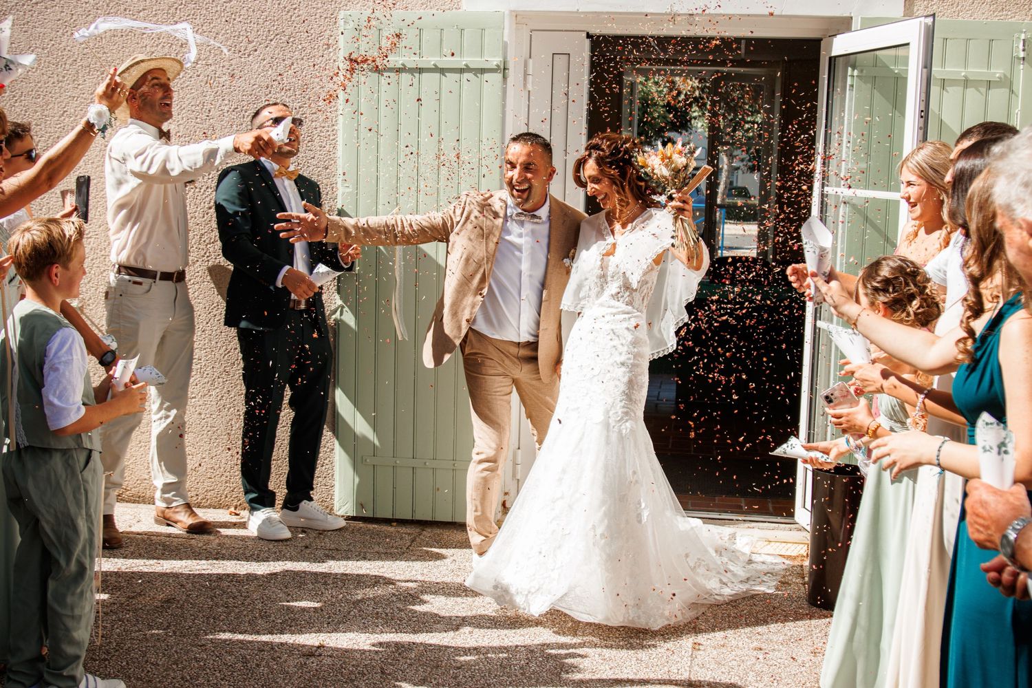 Wedding party guests throw confetti and celebrate during outdoor wedding reception sequence.