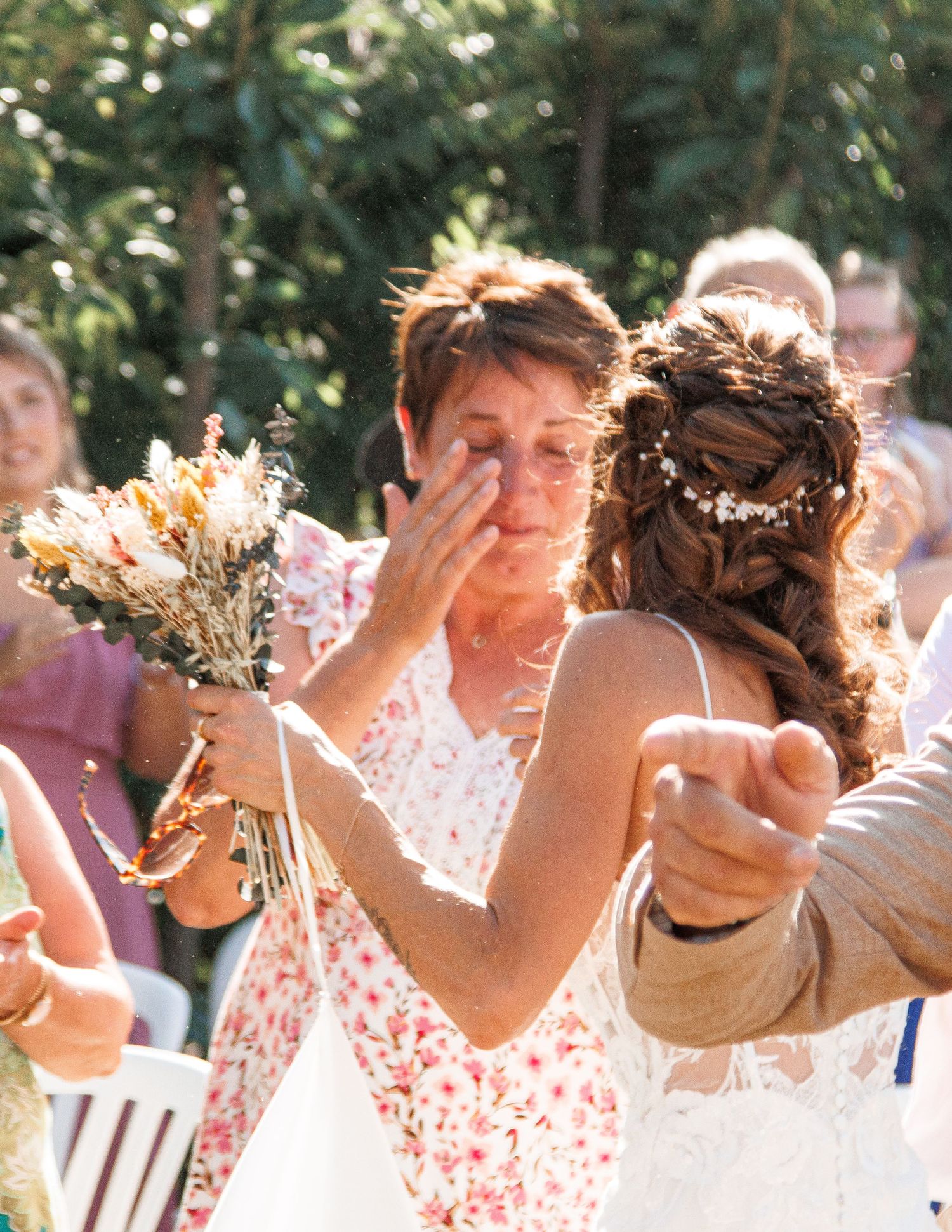 Four connected photos showing people catching bouquets being tossed at a wedding celebration outdoors.
