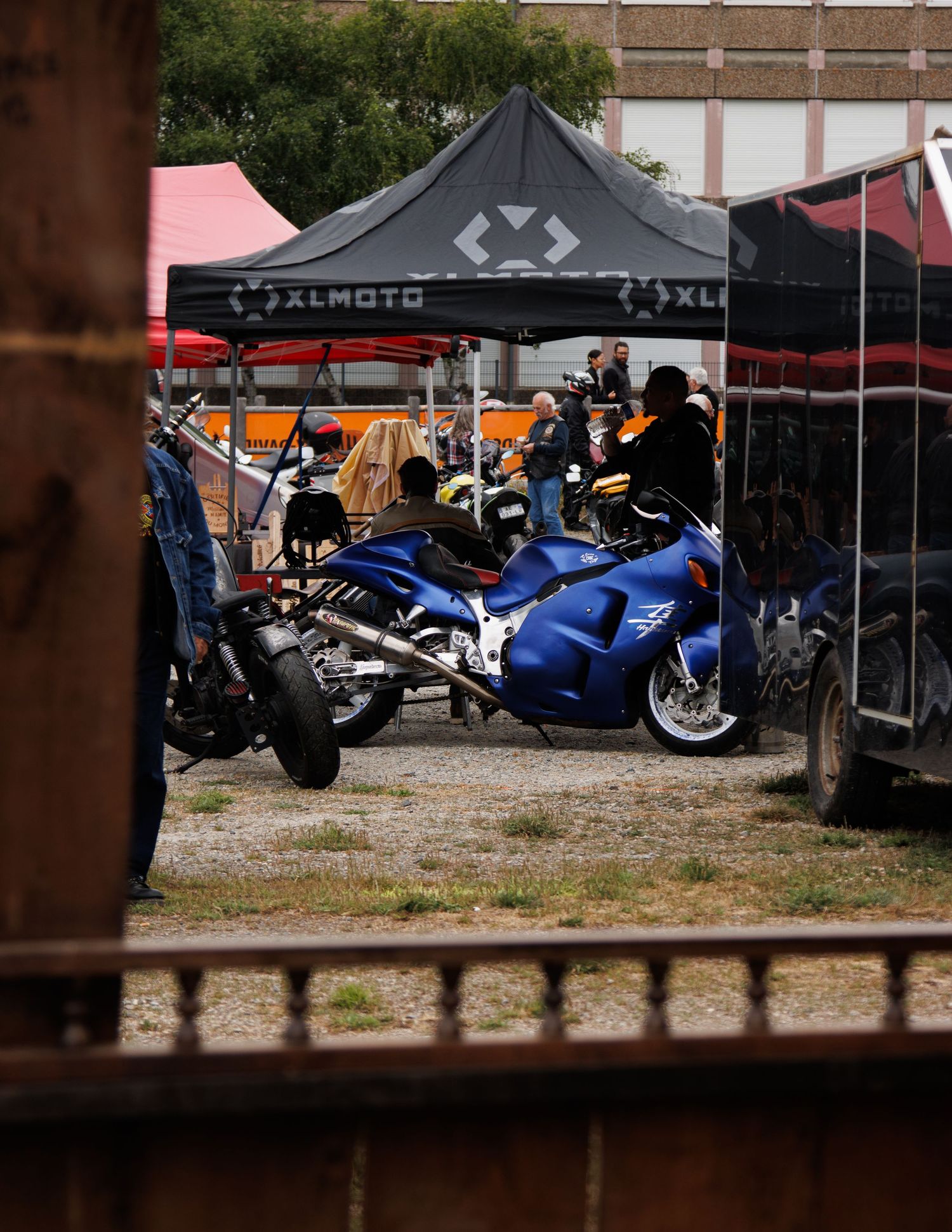 Various motorcycles and vendor tents displayed at an outdoor event.
