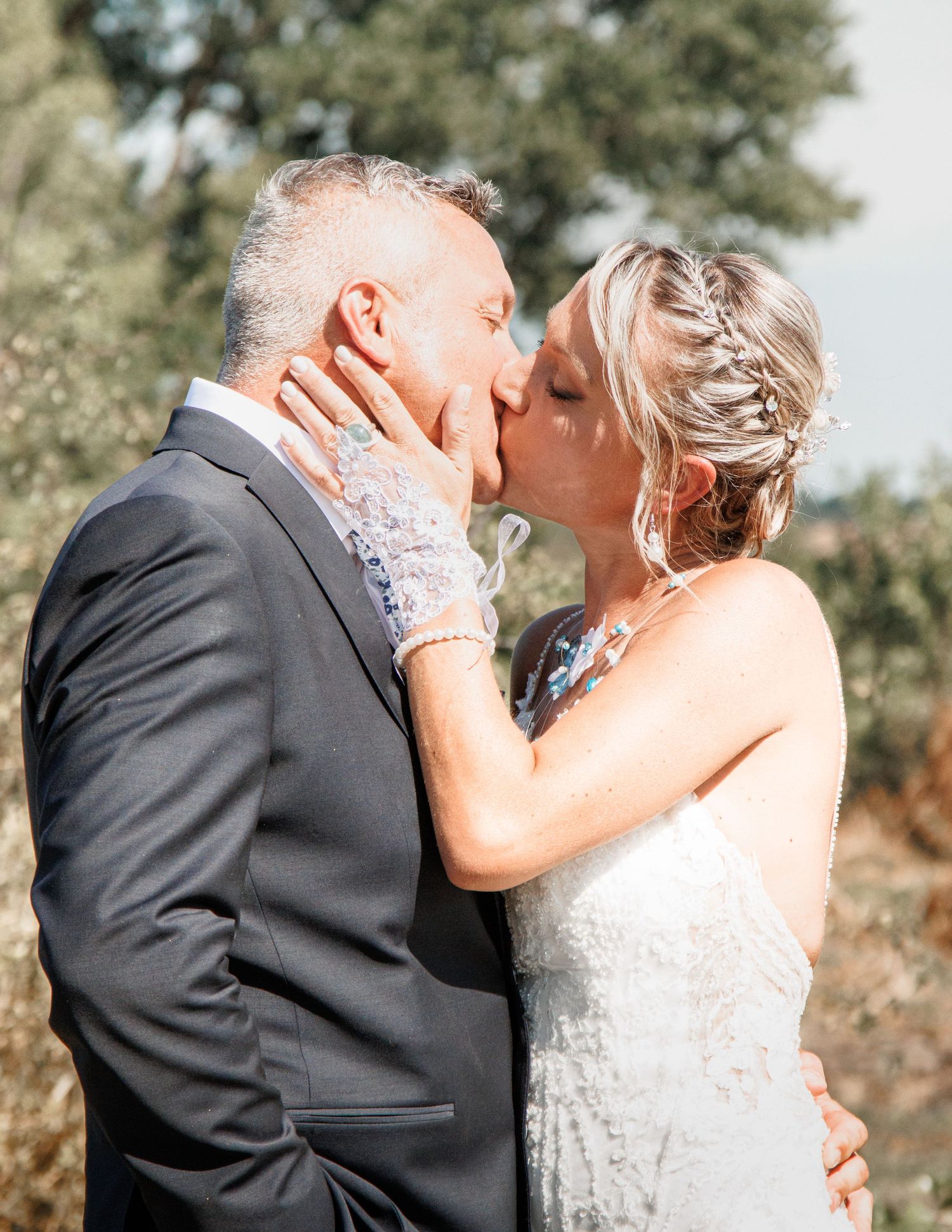 An intimate wedding portrait showing a romantic kiss between the newlyweds.