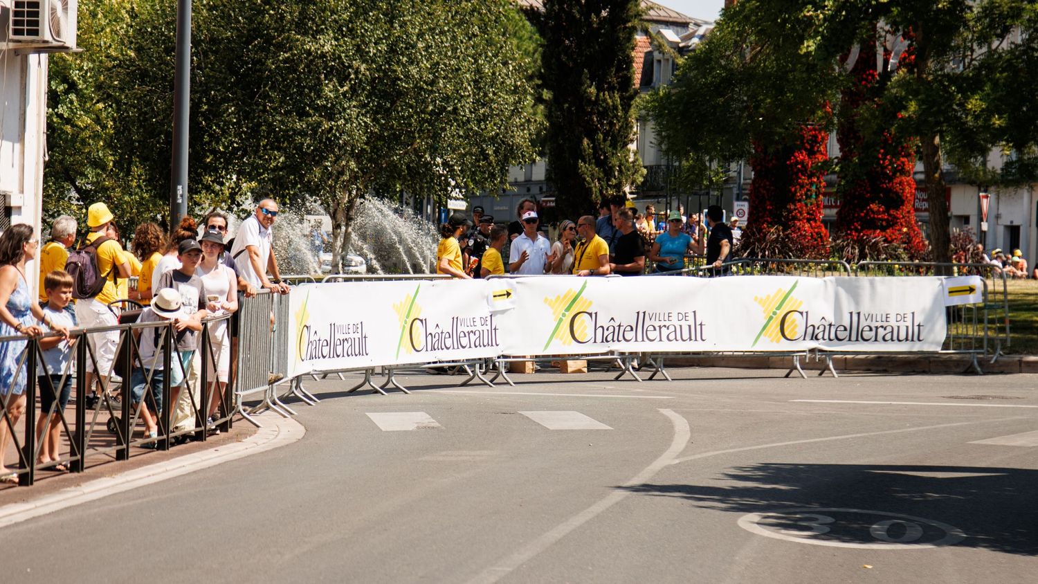 Empty race course with sponsor banners and barriers along the route.