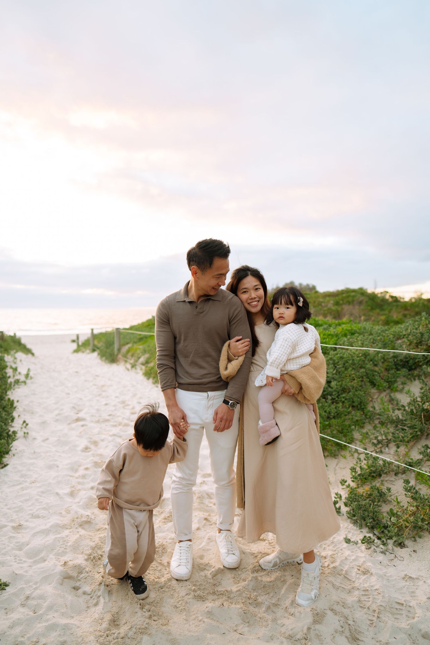 Perth Family Photographer Perth Family Photographer, happy beach perth photoshoot mum and dad and two toddler girls candid
