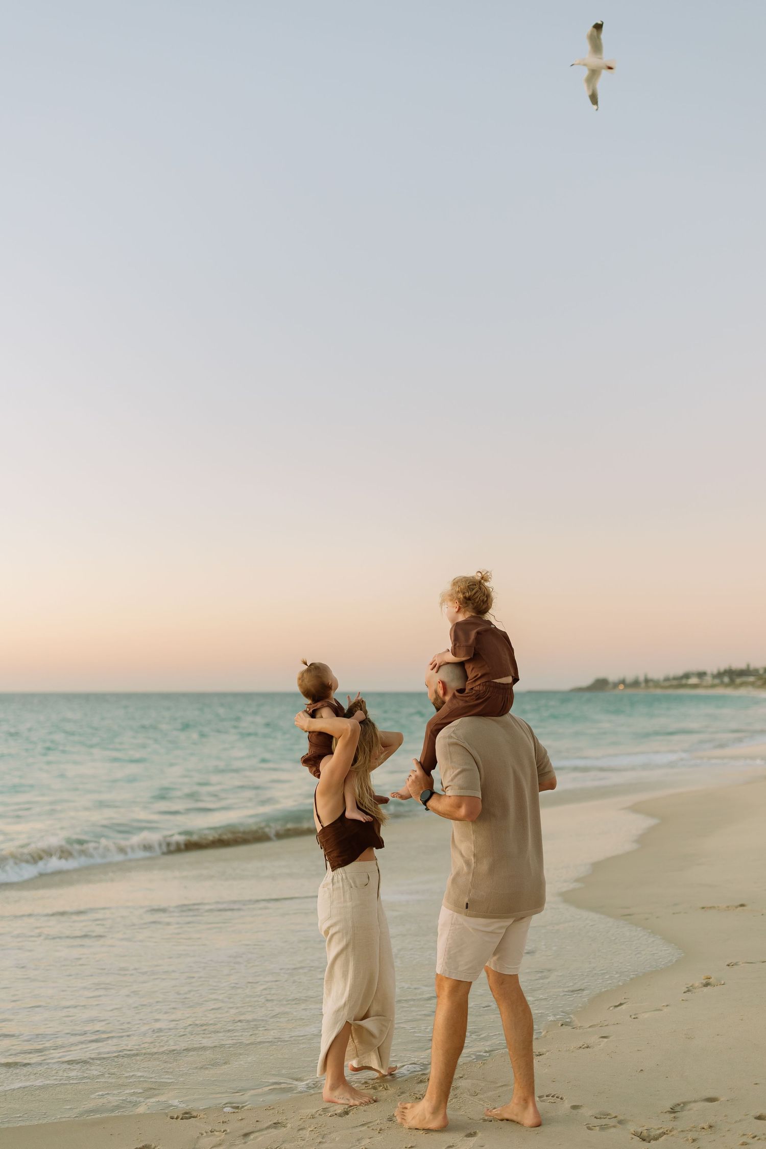 Perth Family Photographer golden hour, twilight beach session Perth Family Photographer, happy beach perth photoshoot mum and dad and two to