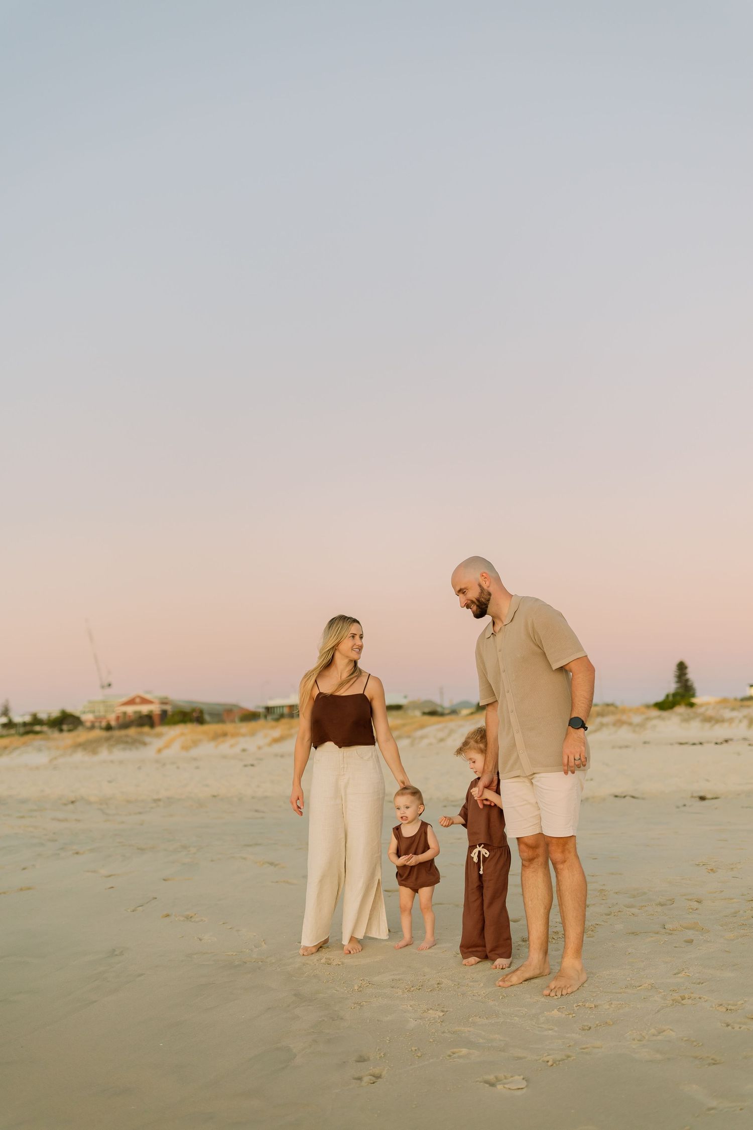 Perth Family Photographer, happy beach perth photoshoot mum and dad and two toddler girls candid