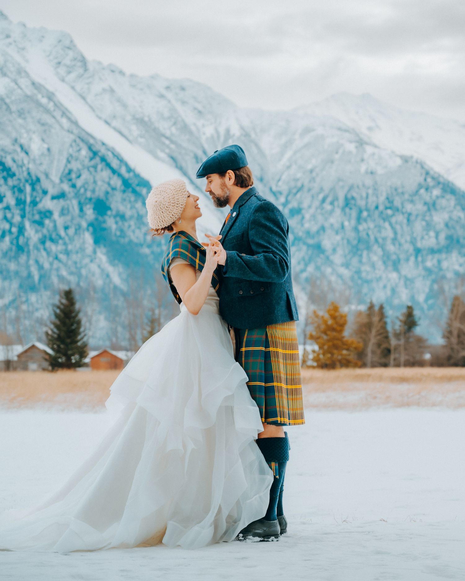 Snow-capped mountains provide a stunning winter backdrop for a romantic moment.
