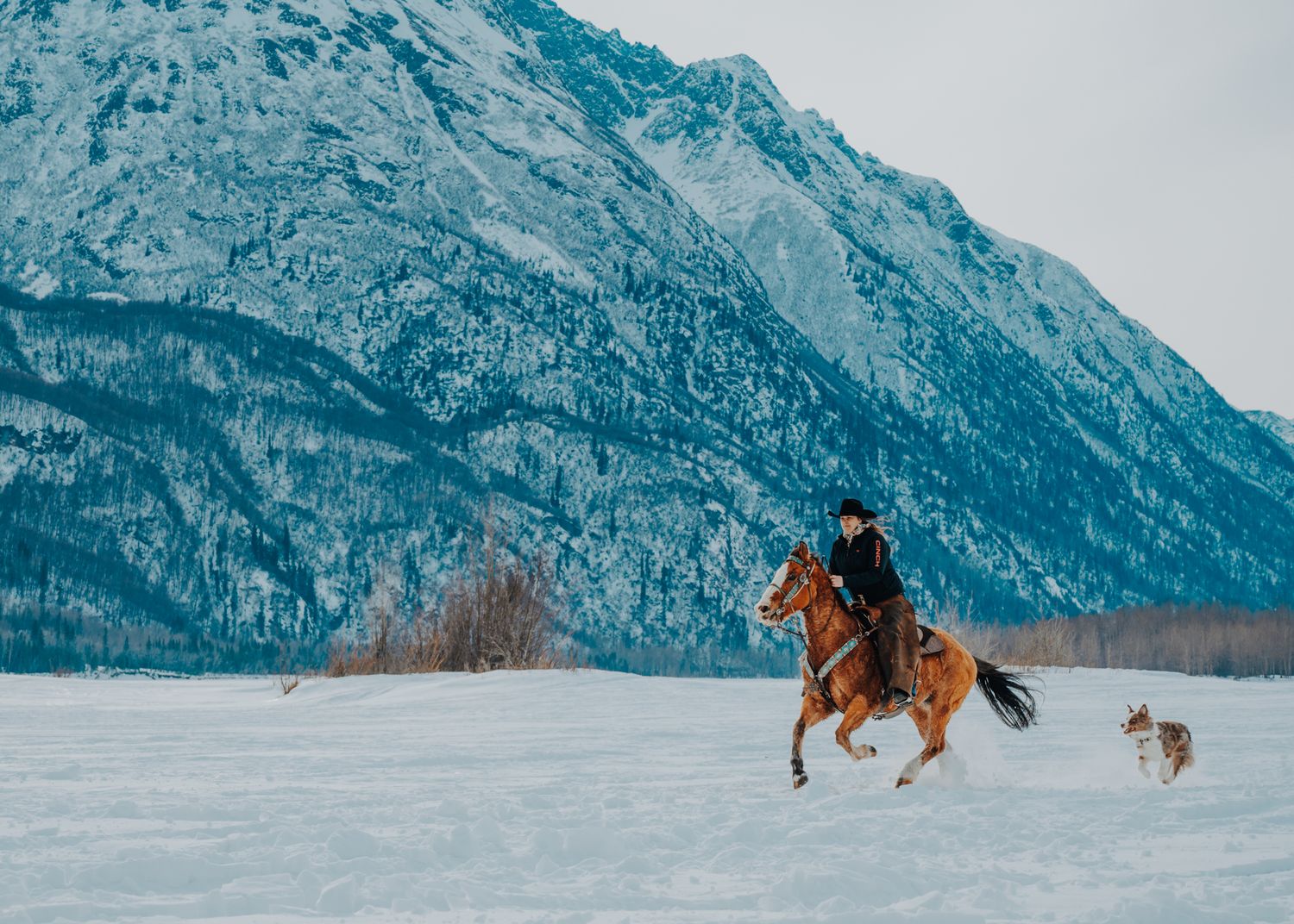 Cowgirl riding in winter in Alaska, North and Wild