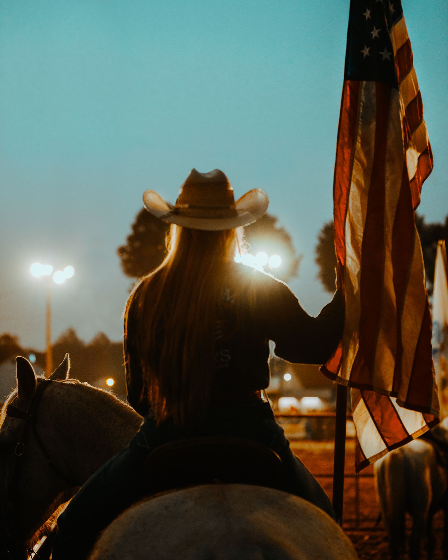 Cowgirl with American flag in Missouri Rodeo Photographer Image by North and Wild