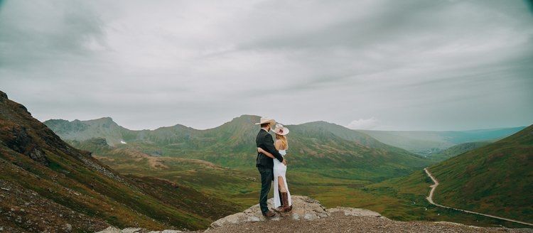 Scenic mountain landscape views with dramatic cloudy skies over rugged terrain.