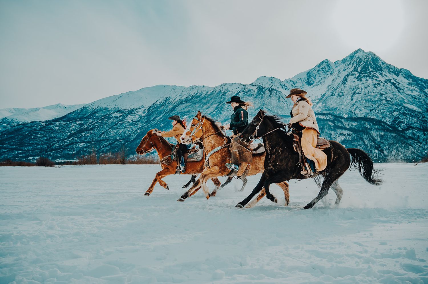 Cowgirl riding in winter in Alaska, North and Wild