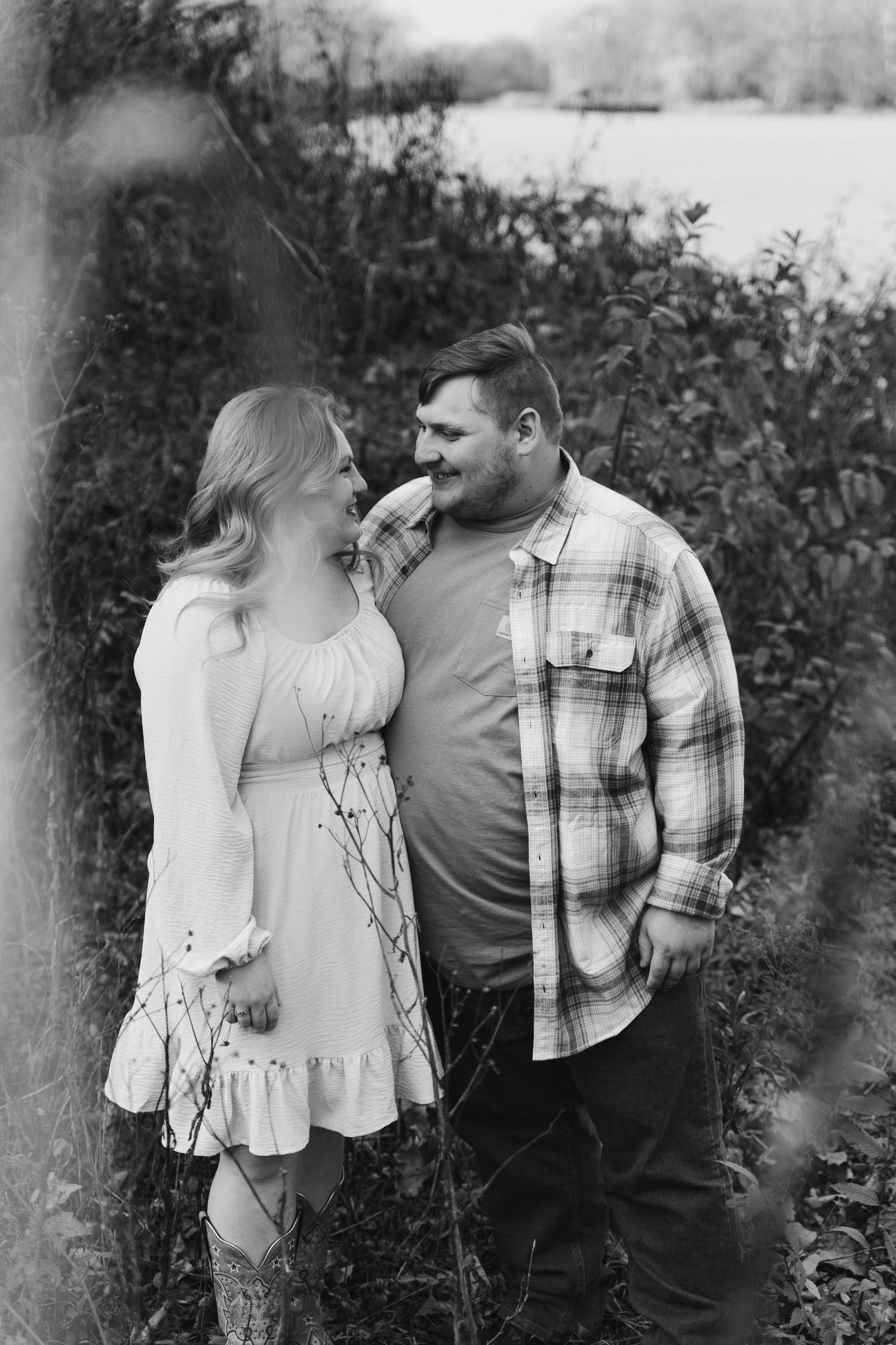 A black and white series showing a couple sharing romantic moments among outdoor greenery.