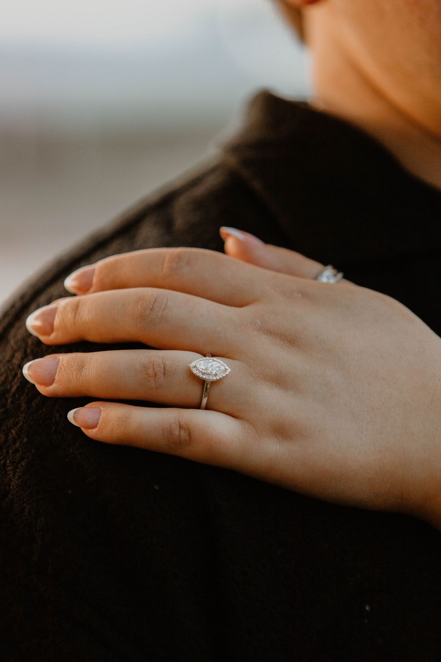 Close-up shots of a diamond engagement ring on a hand against a dark background.