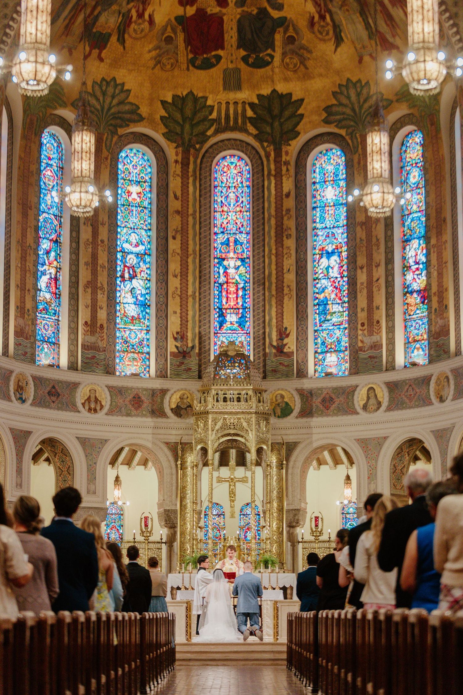 A church wedding ceremony in a grand cathedral with stunning stained glass windows and ornate architecture.