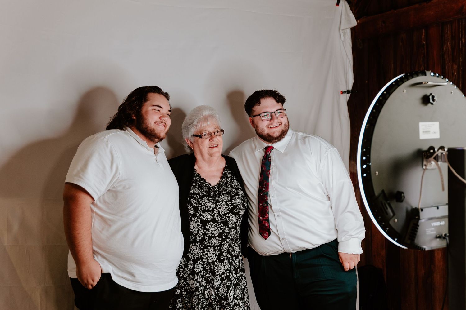 A series of candid black and white wedding photos showing intimate moments between guests and the couple.