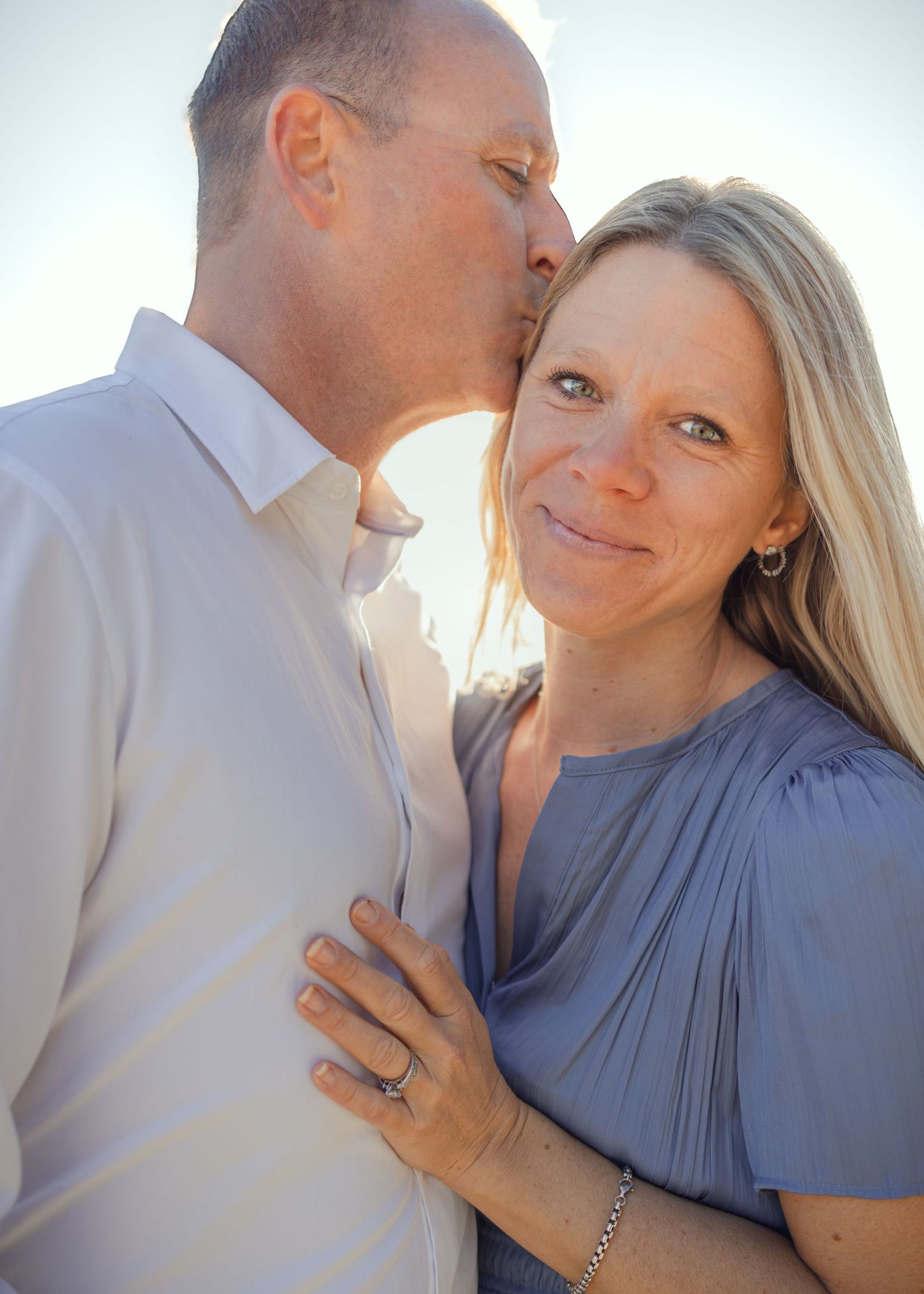 A couple in casual attire share intimate moments in a series of romantic outdoor photos at sunset.