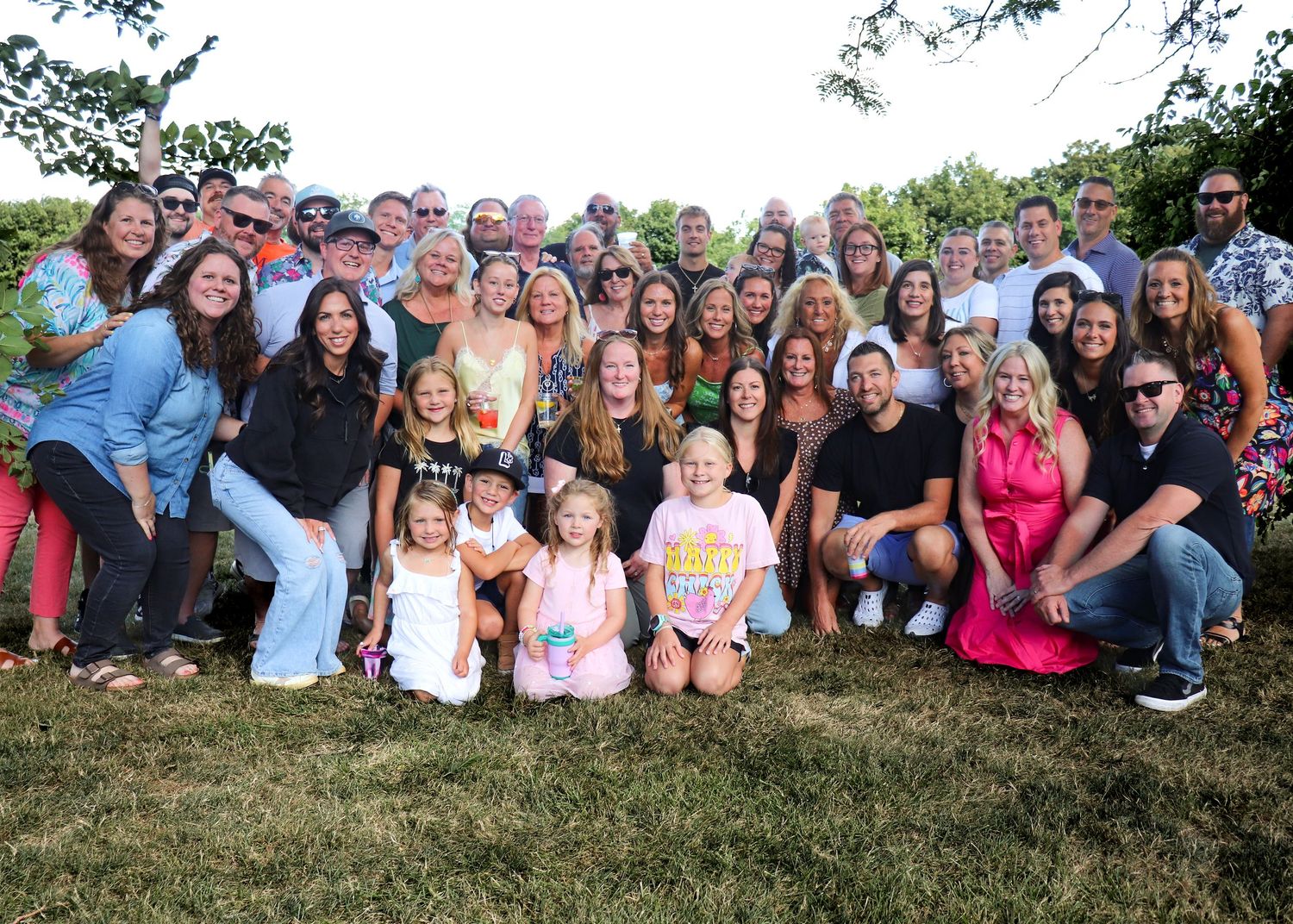 A collage of four wide group photos taken outdoors showing multiple people gathered together side by side.