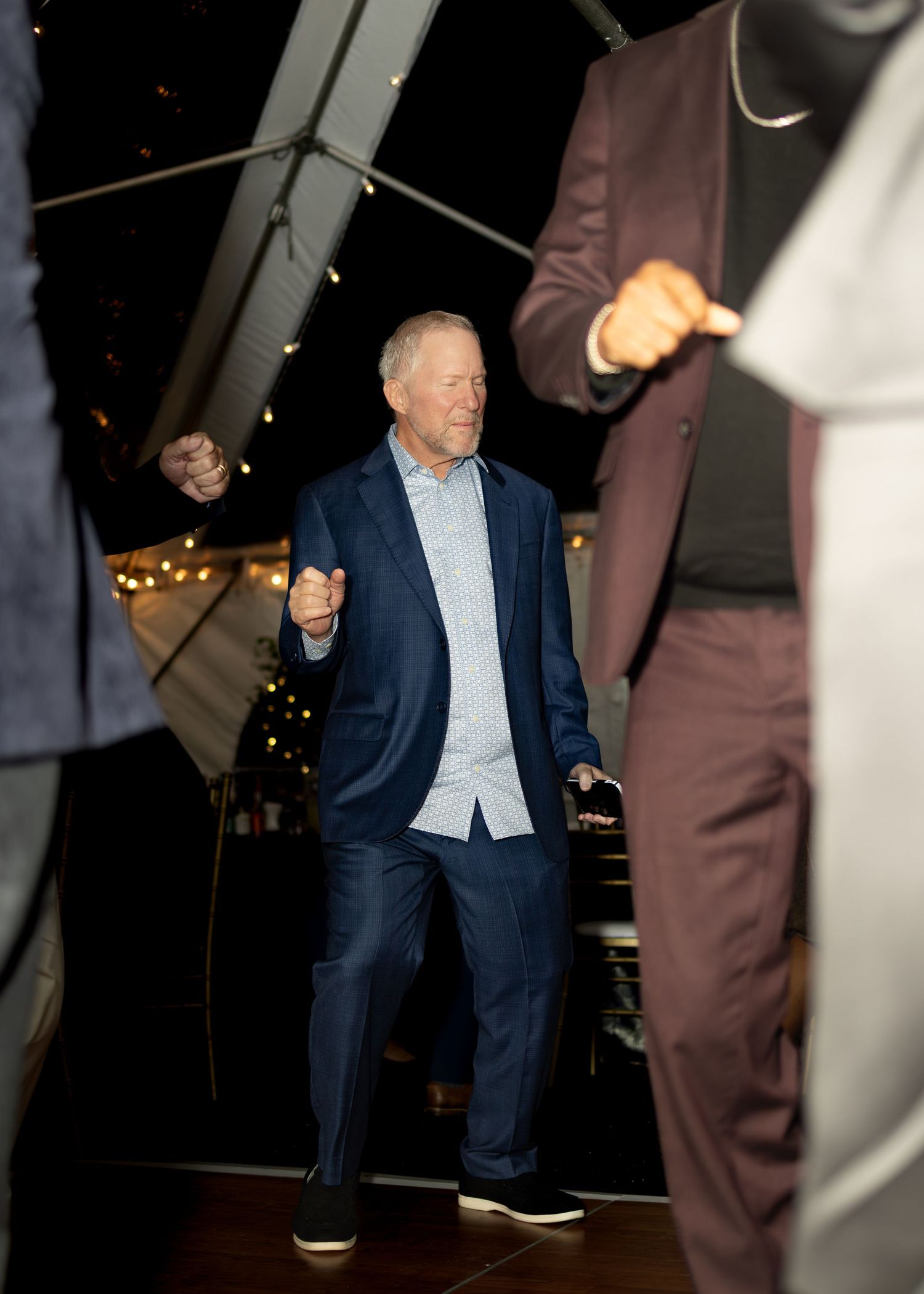 Dance floor scene at an evening event with people in formal attire enjoying the celebration.