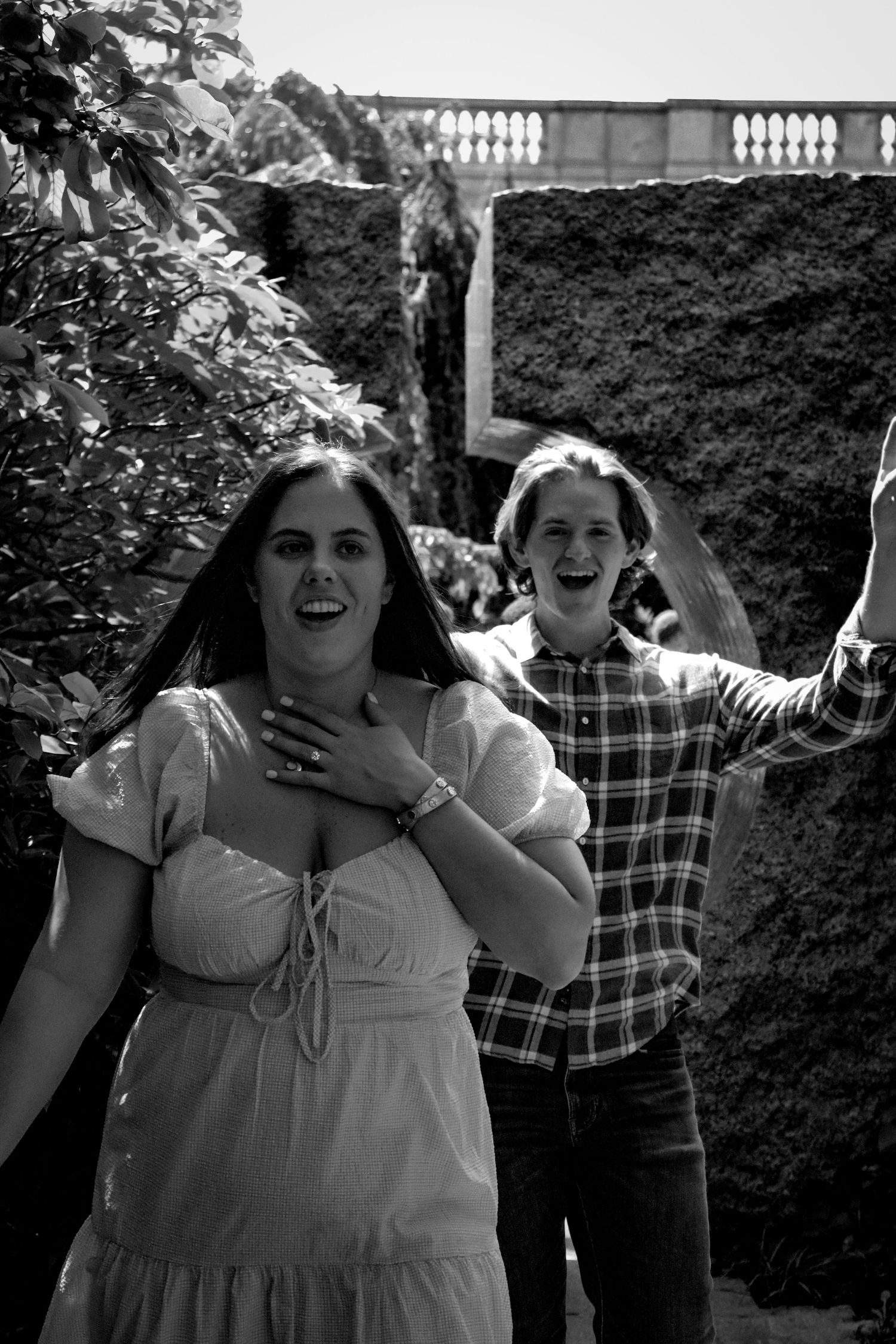 Couple laughing together in black and white garden photo, candid engagement photography in Washington DC.
