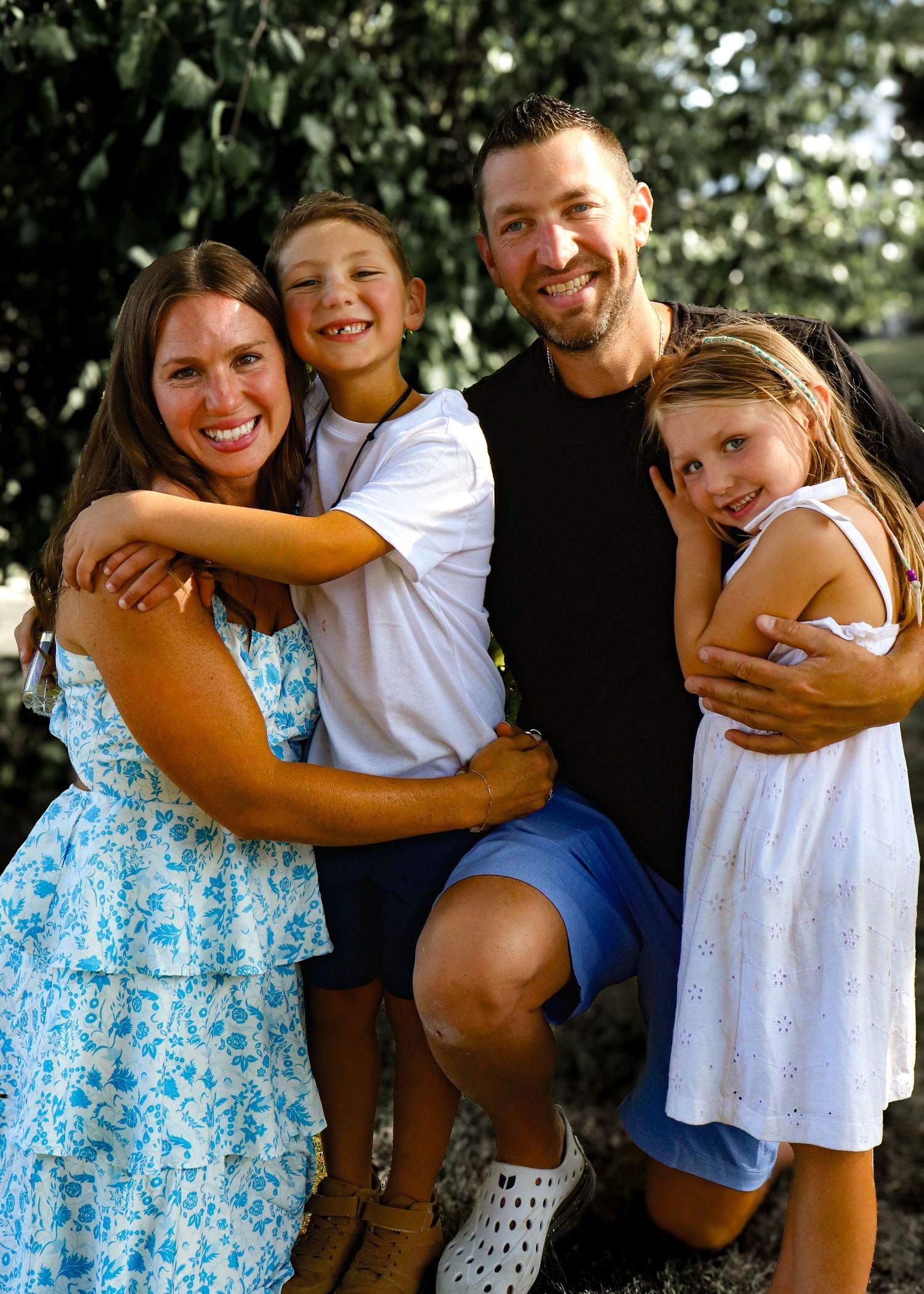 A sweet candid photo series showing siblings sharing warm hugs and laughter in an outdoor setting.