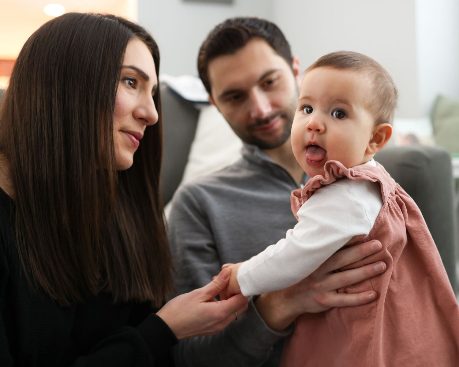 A series of candid family moments showing parents interacting with their baby in warm, intimate indoor portraits.
