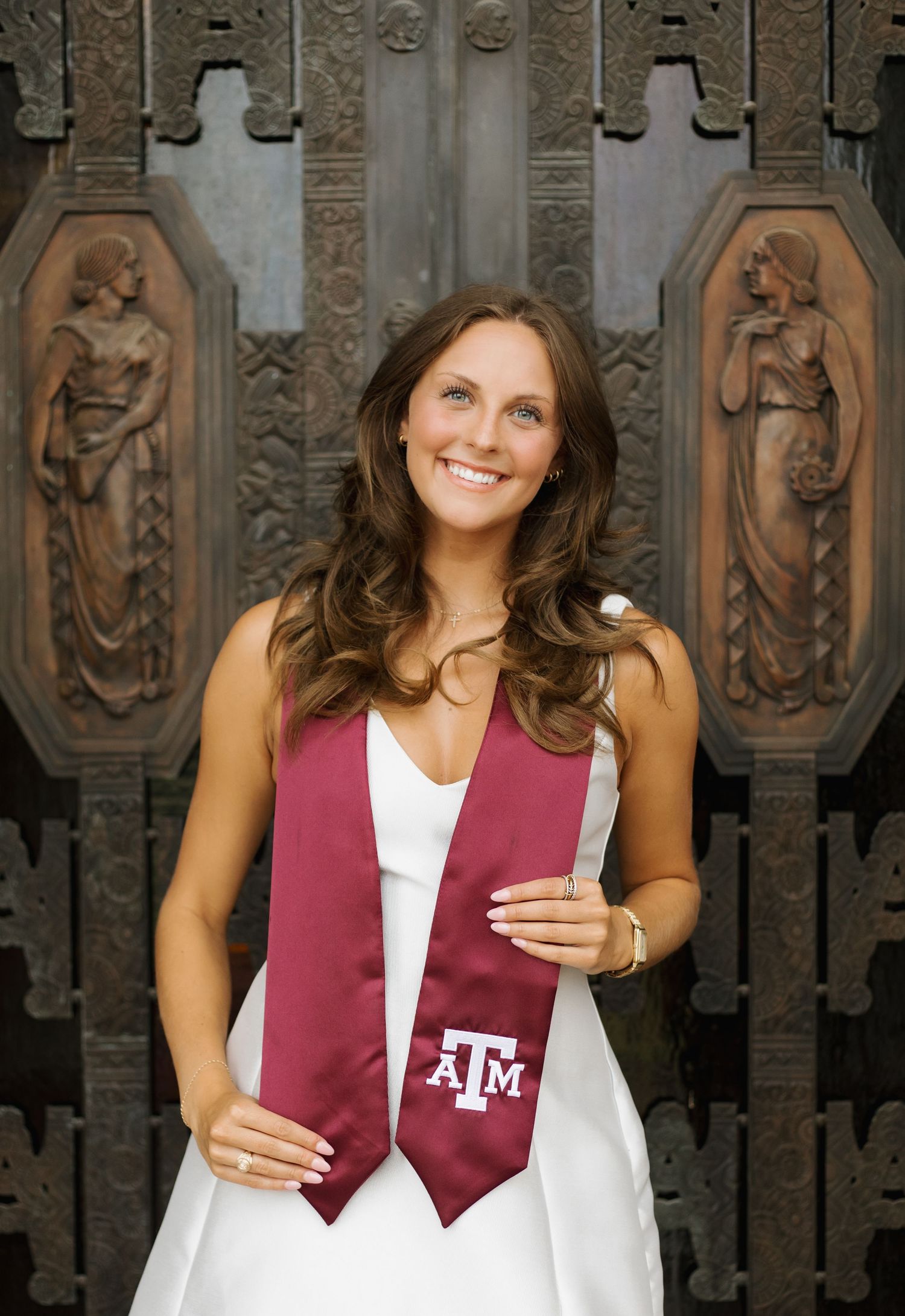 Graduation photos featuring maroon Texas A&M stole against ornate architectural background.