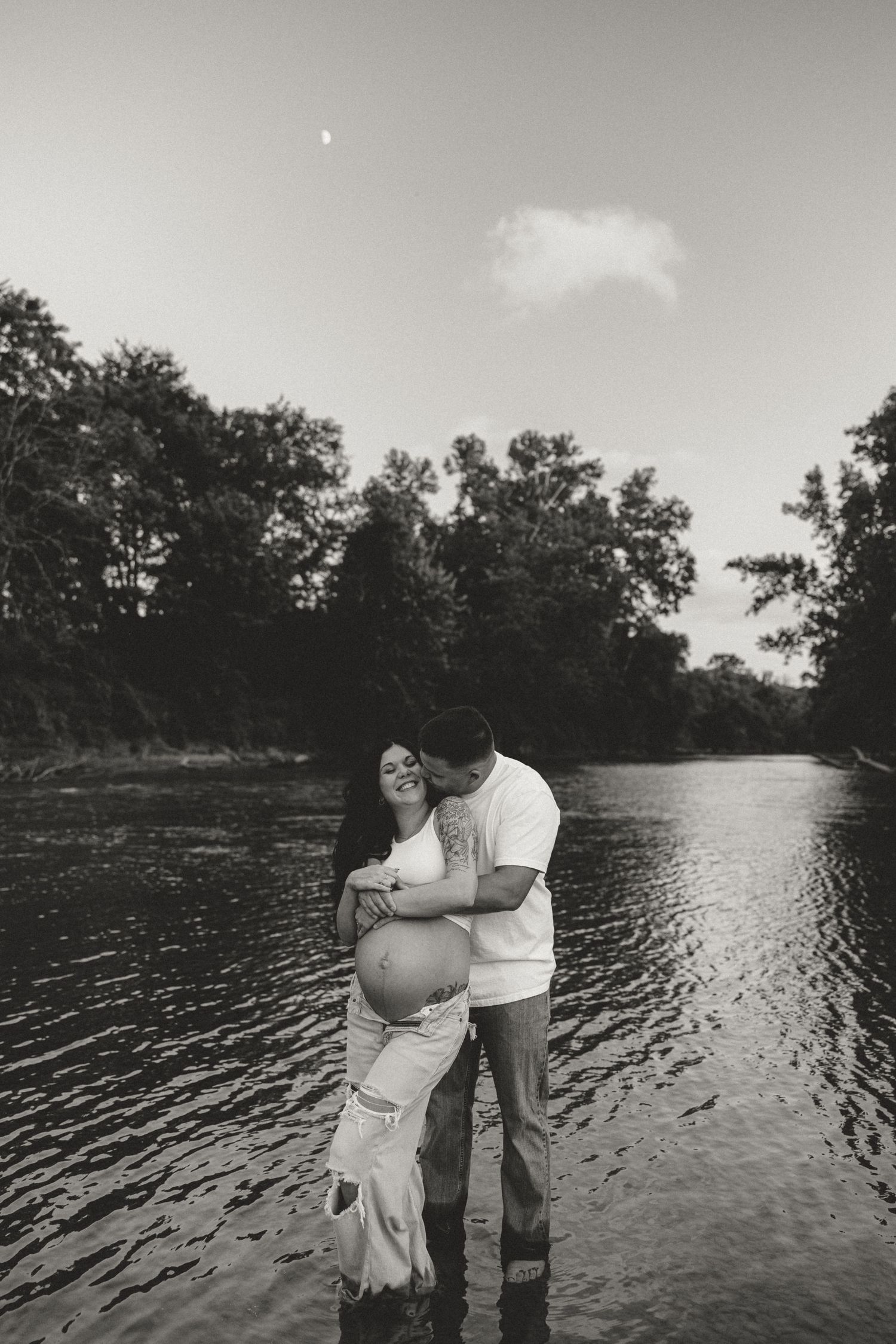A romantic sequence of black and white photos showing two people embracing by a serene lake at sunset.