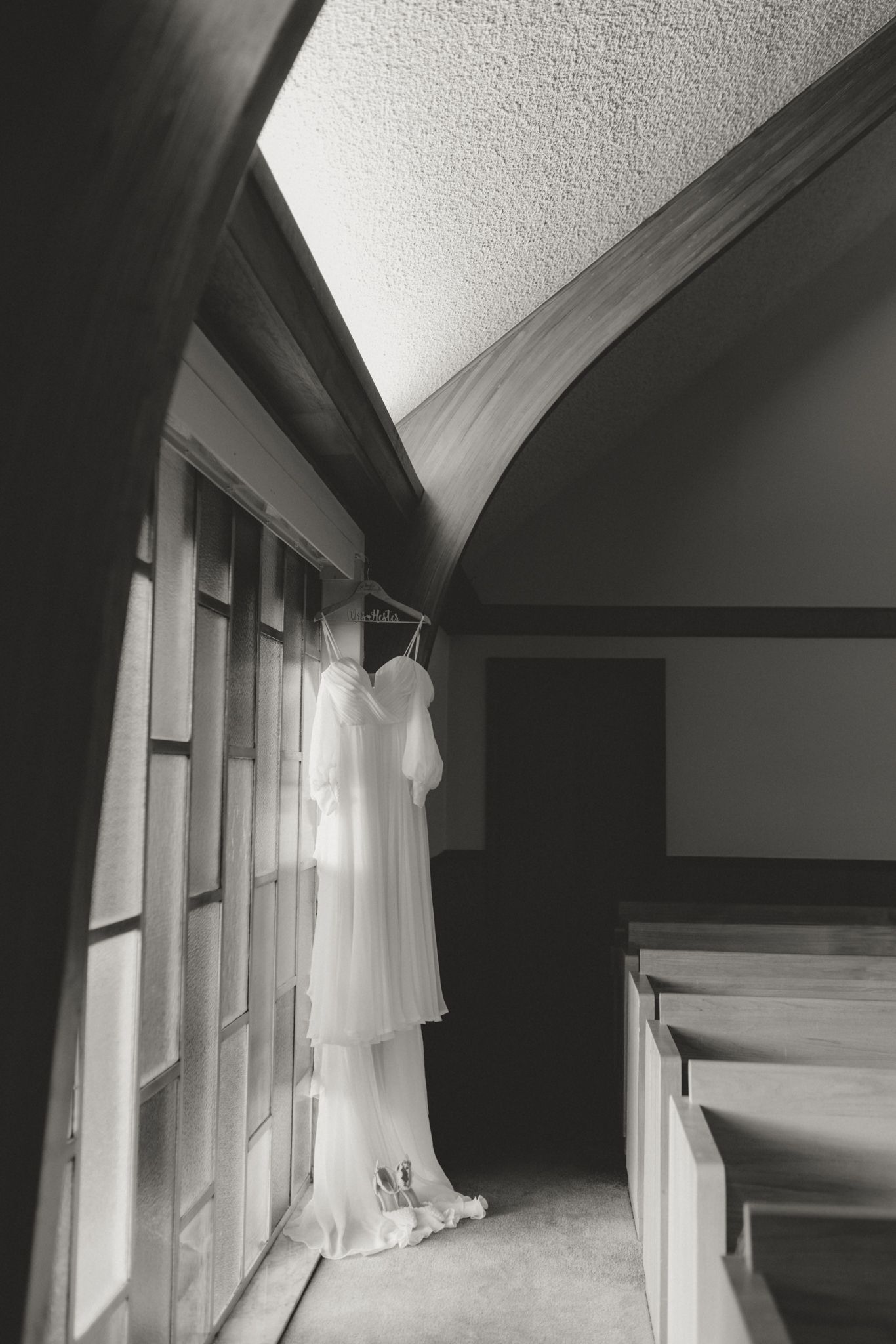 A sequence of black and white photographs showing a ghostly white dress hanging near windows in different angles.