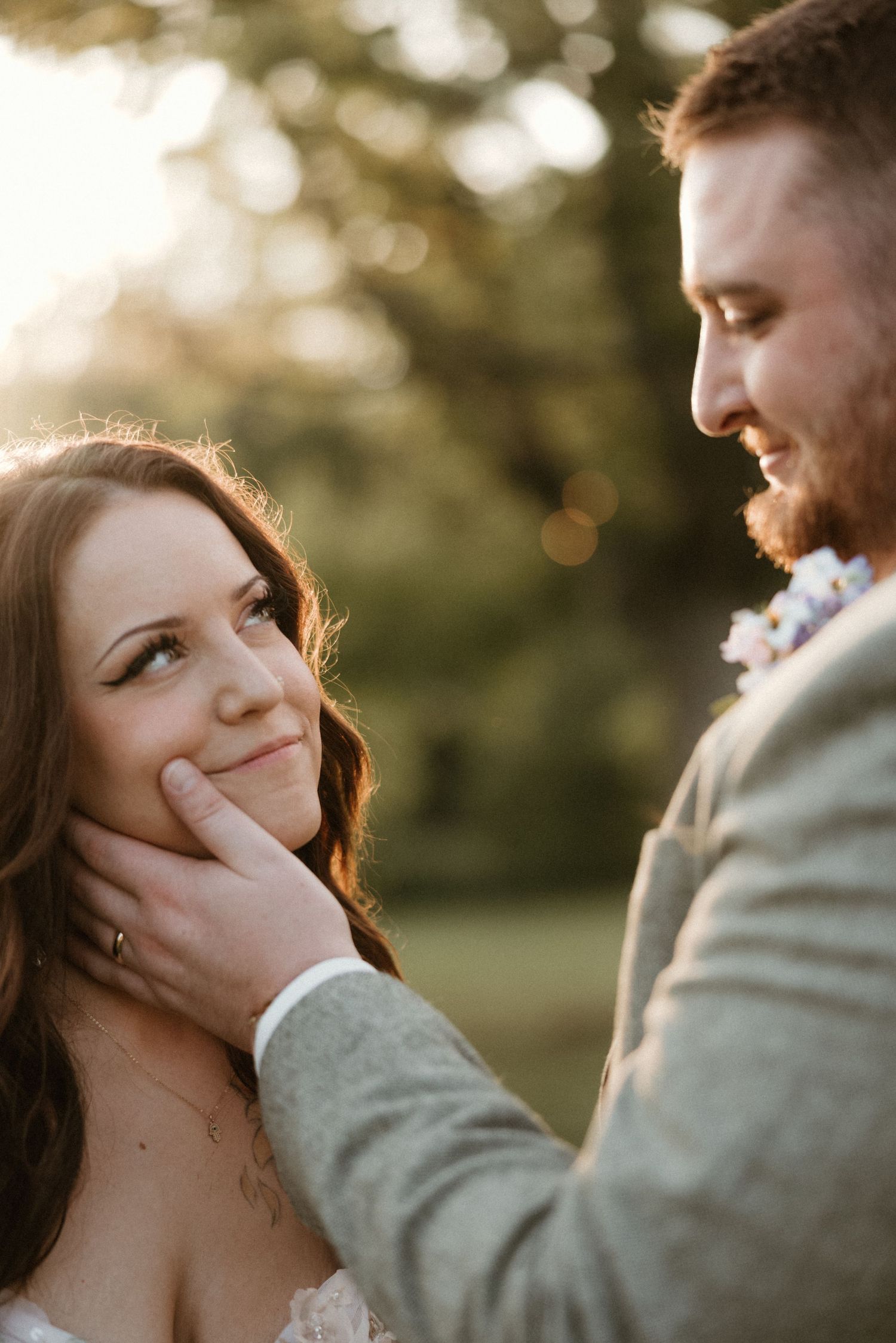 Intimate wedding couple shares tender moments during golden hour sunset photoshoot.