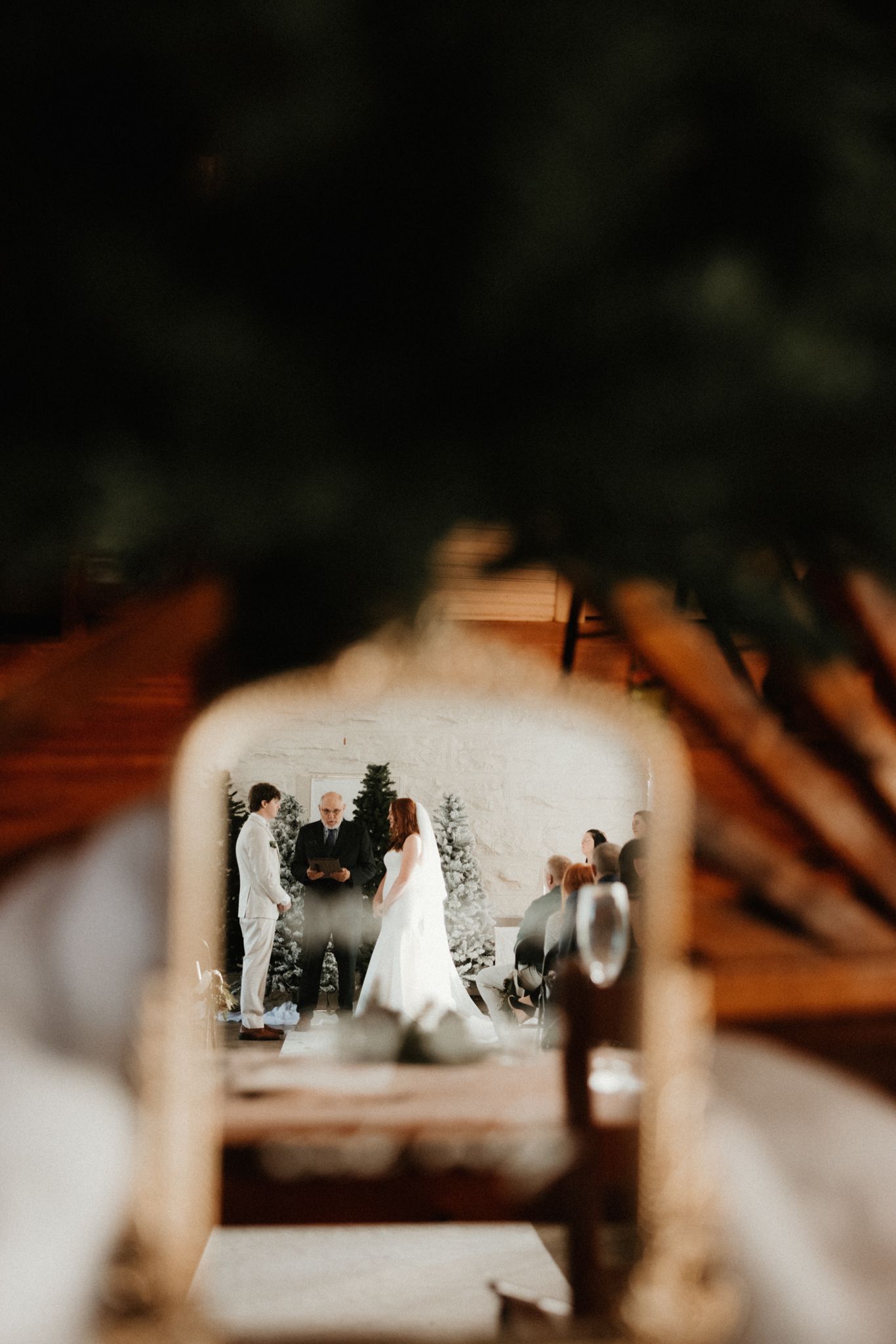 Wedding ceremony scene reflected in a mirror with soft, dreamy lighting effects.