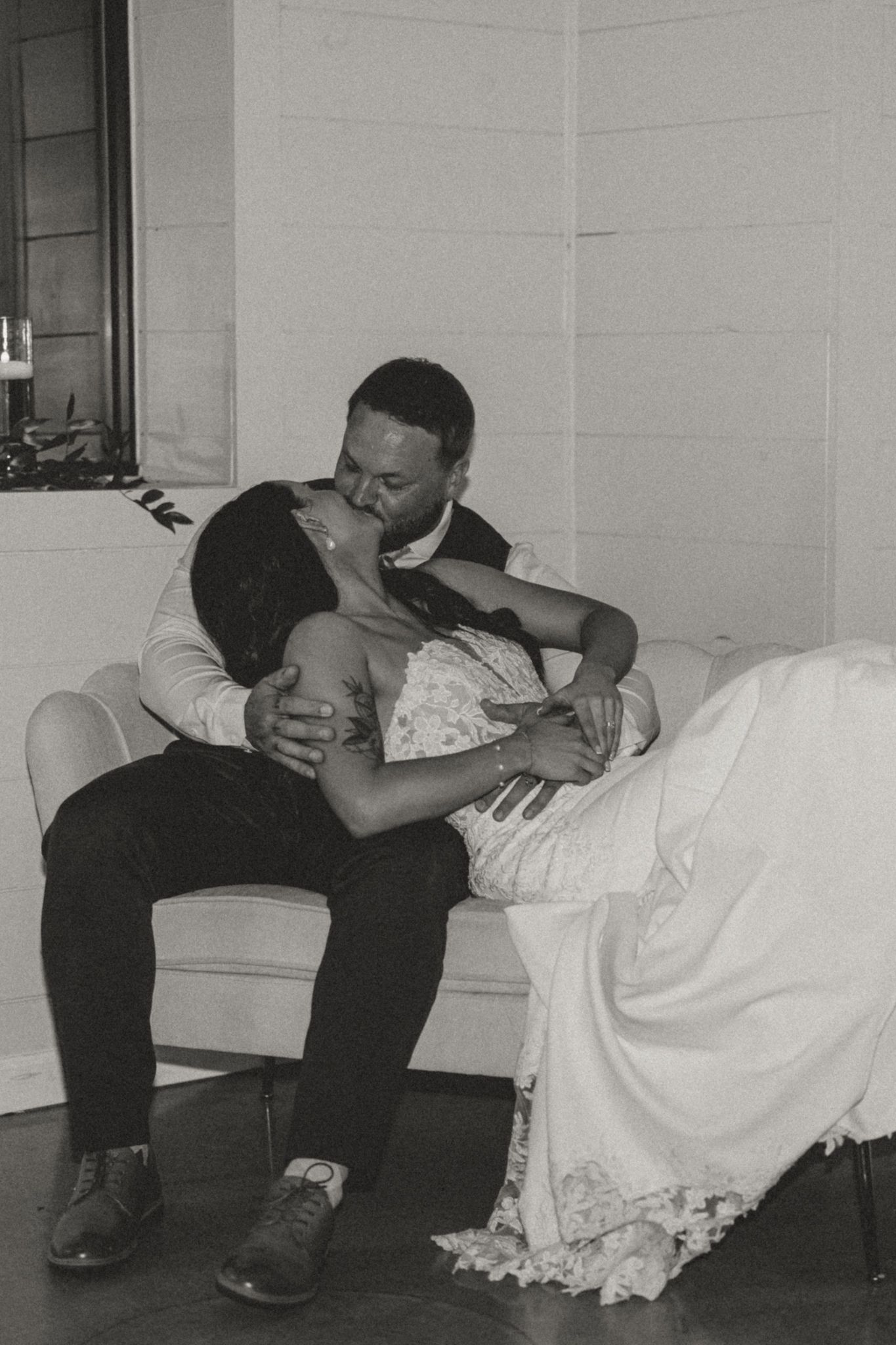 Artistic black and white wedding photos showing intimate moments between a couple on the floor.