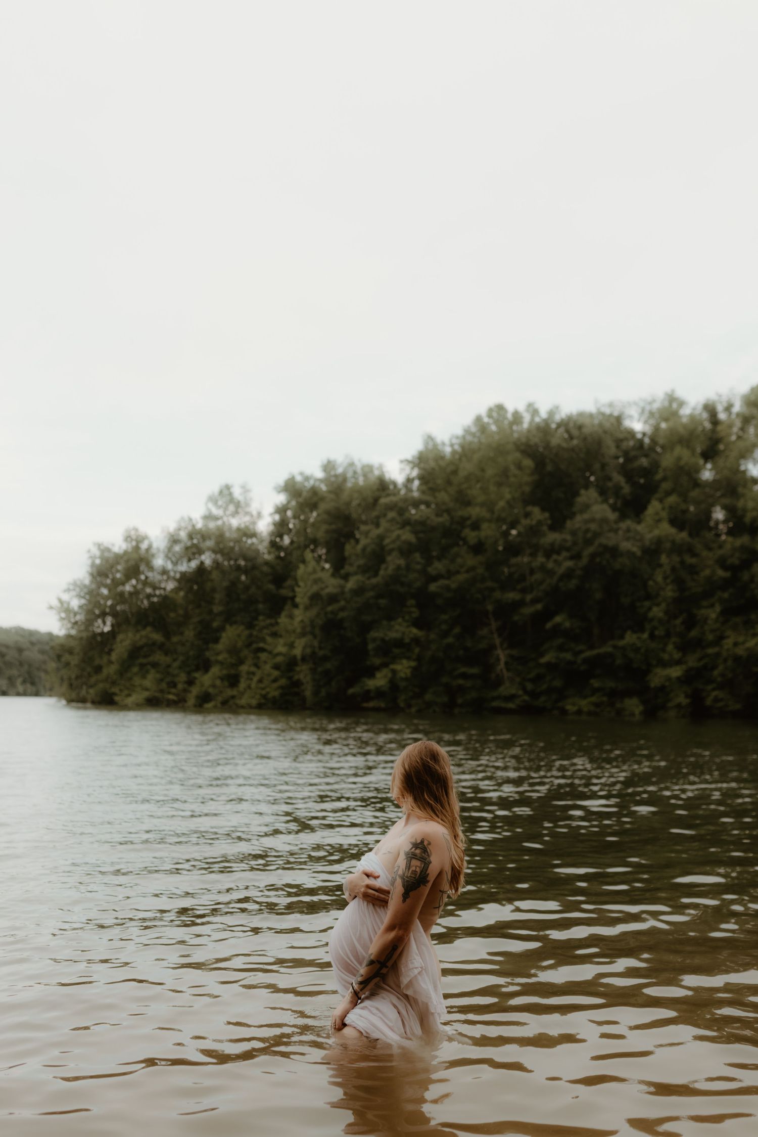 A sequence of photos shows a figure wading and dipping into calm lake waters with trees in the background.
