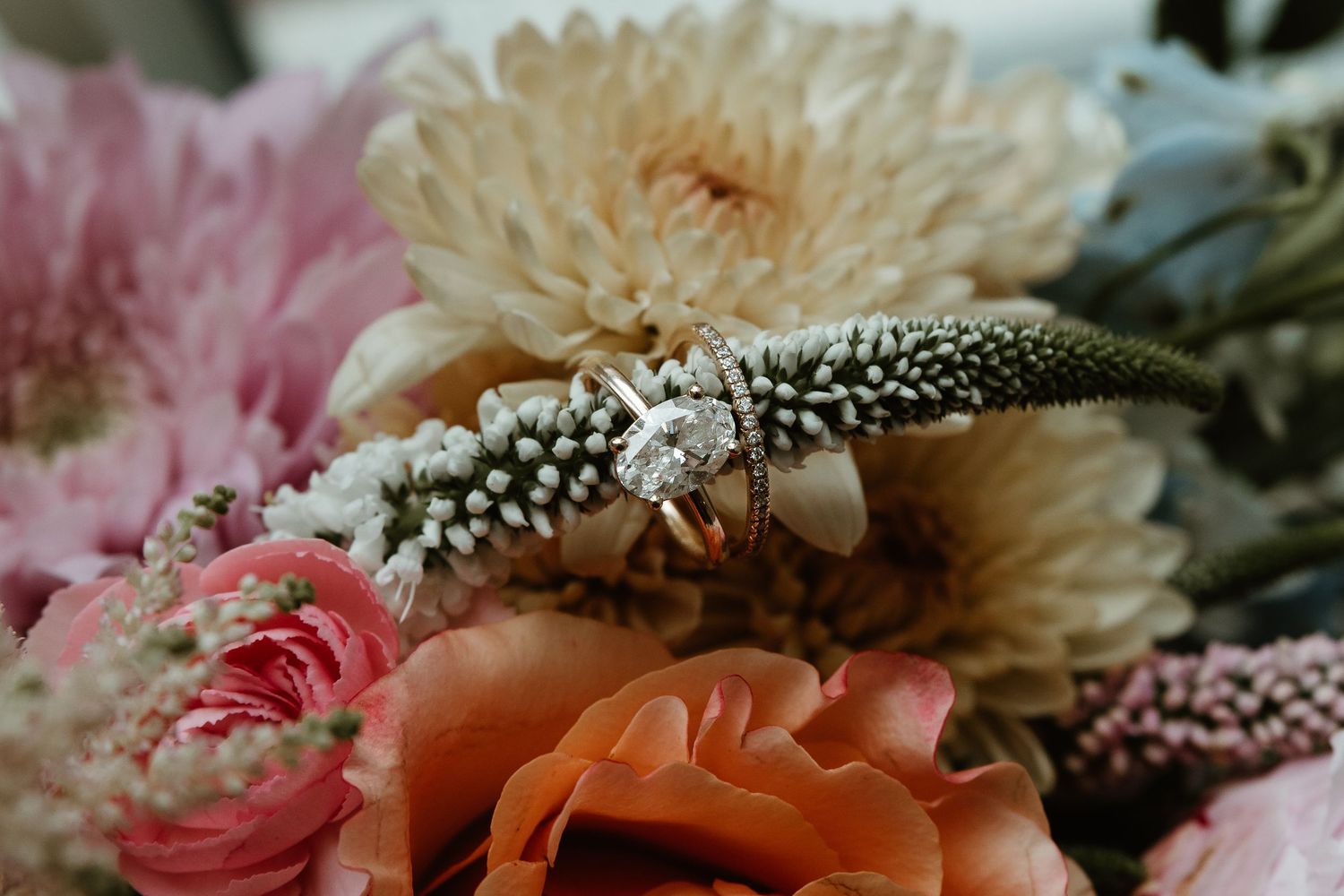 Romantic floral arrangement with peach and pink roses, chrysanthemums and delicate baby's breath blooms.