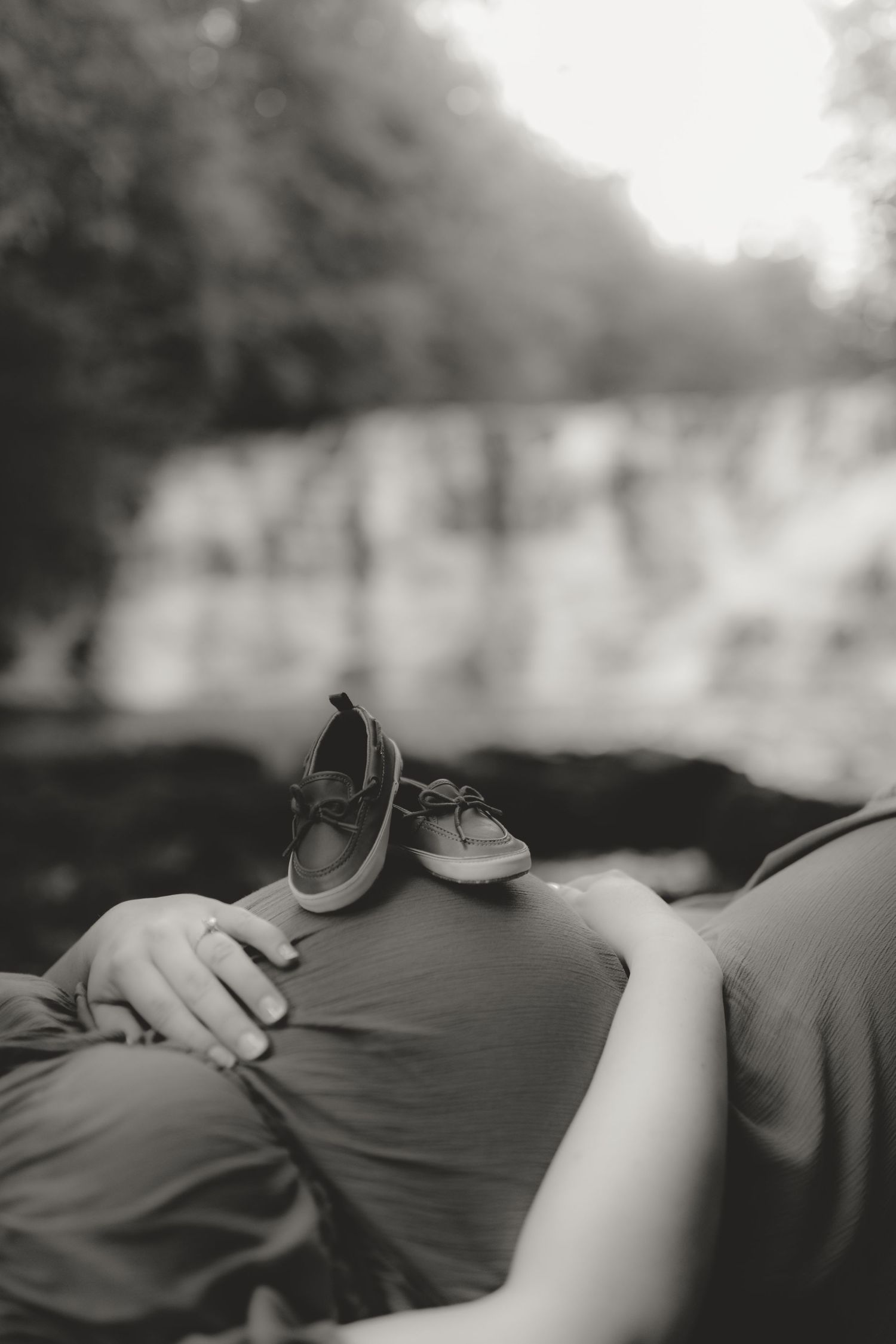 Intimate close-up black and white photo showing gentle hands resting together.
