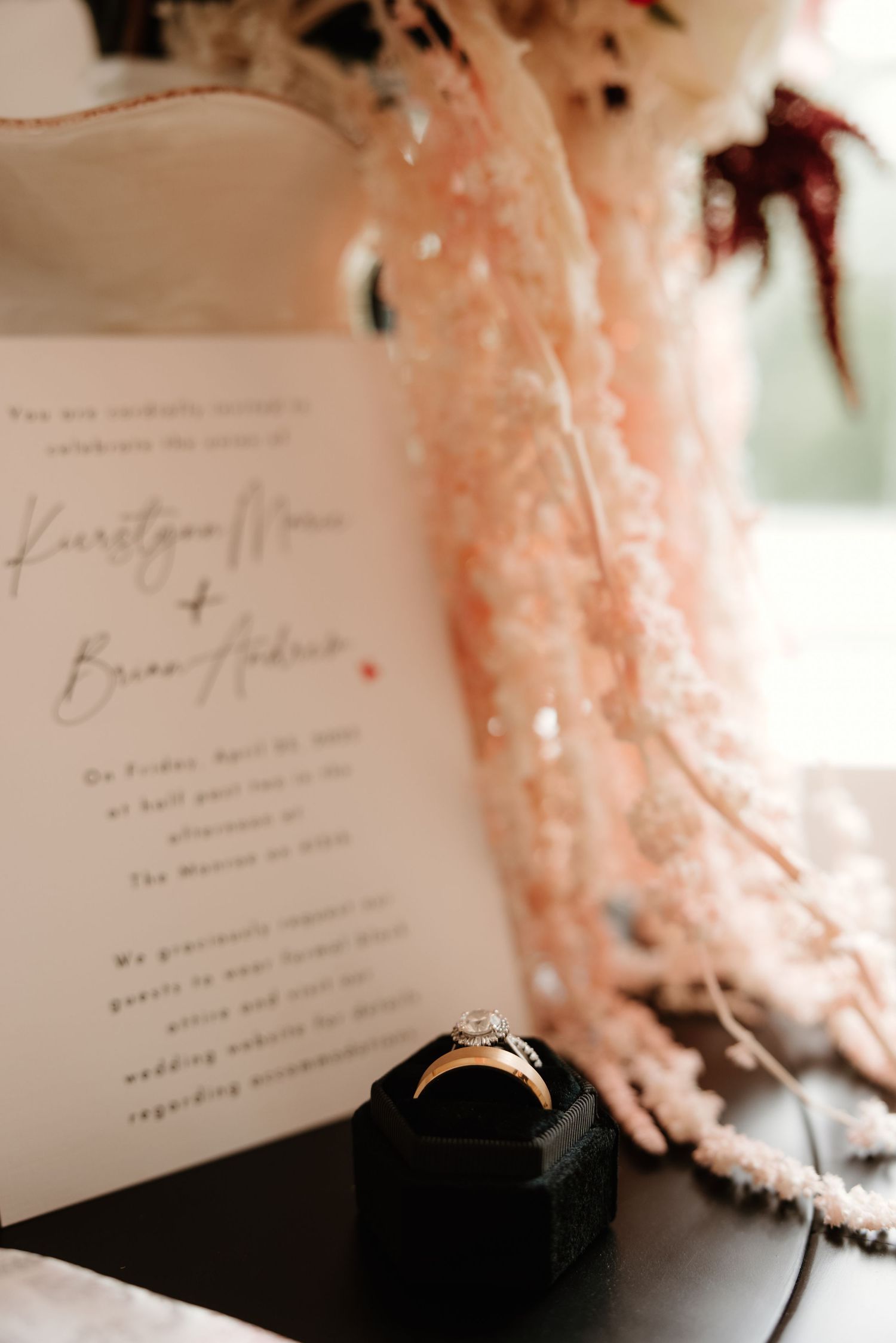 Close-up detail of elegant wedding invitations with blush pink accents.