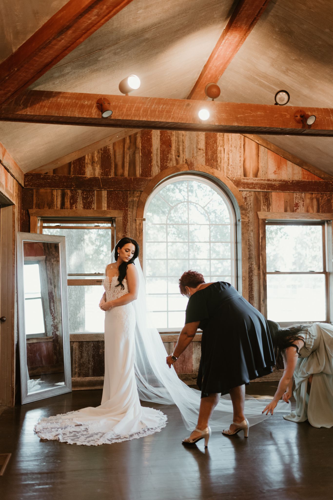 Series of photos showing couple dancing in rustic wooden room with white wedding dress twirling.