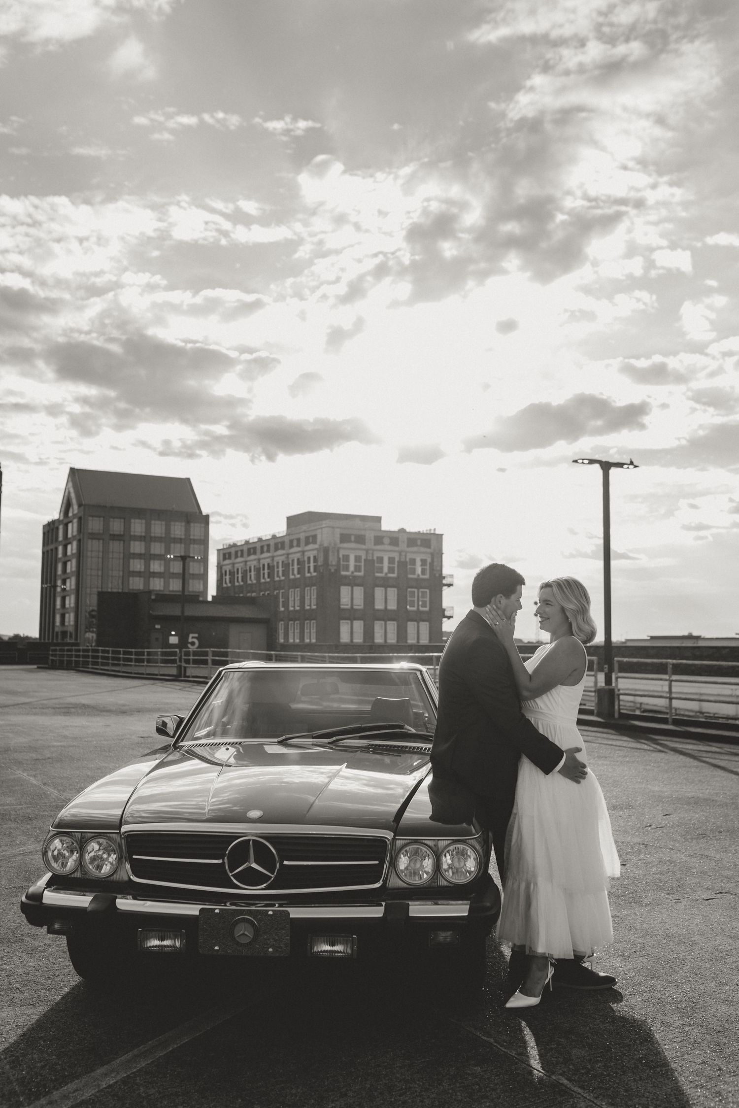 A series of vintage black and white photos showing Mercedes-Benz classic cars and romantic moments against an urban backdrop.
