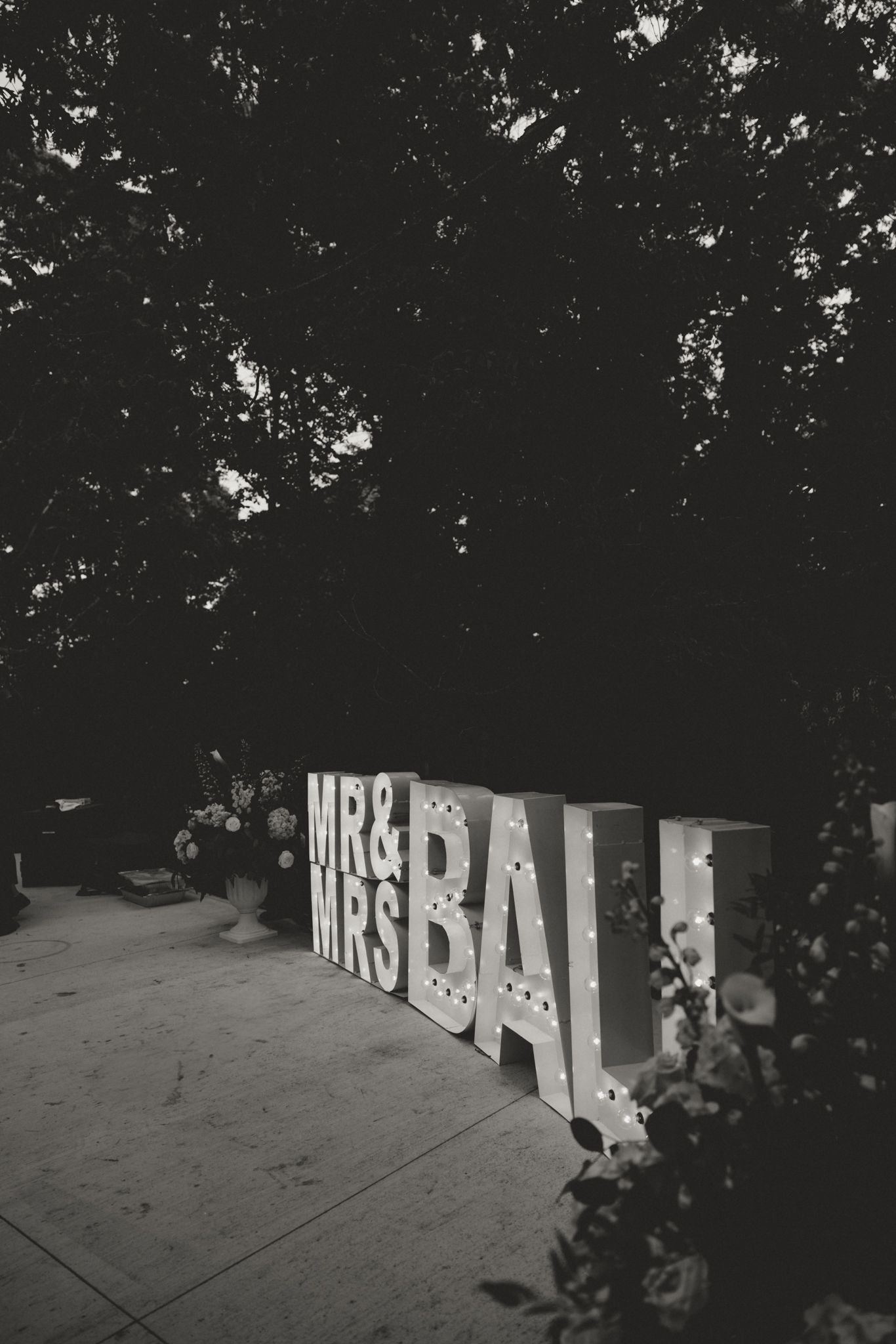 Large decorative letters spelling 'MRS' displayed at an outdoor wedding venue.