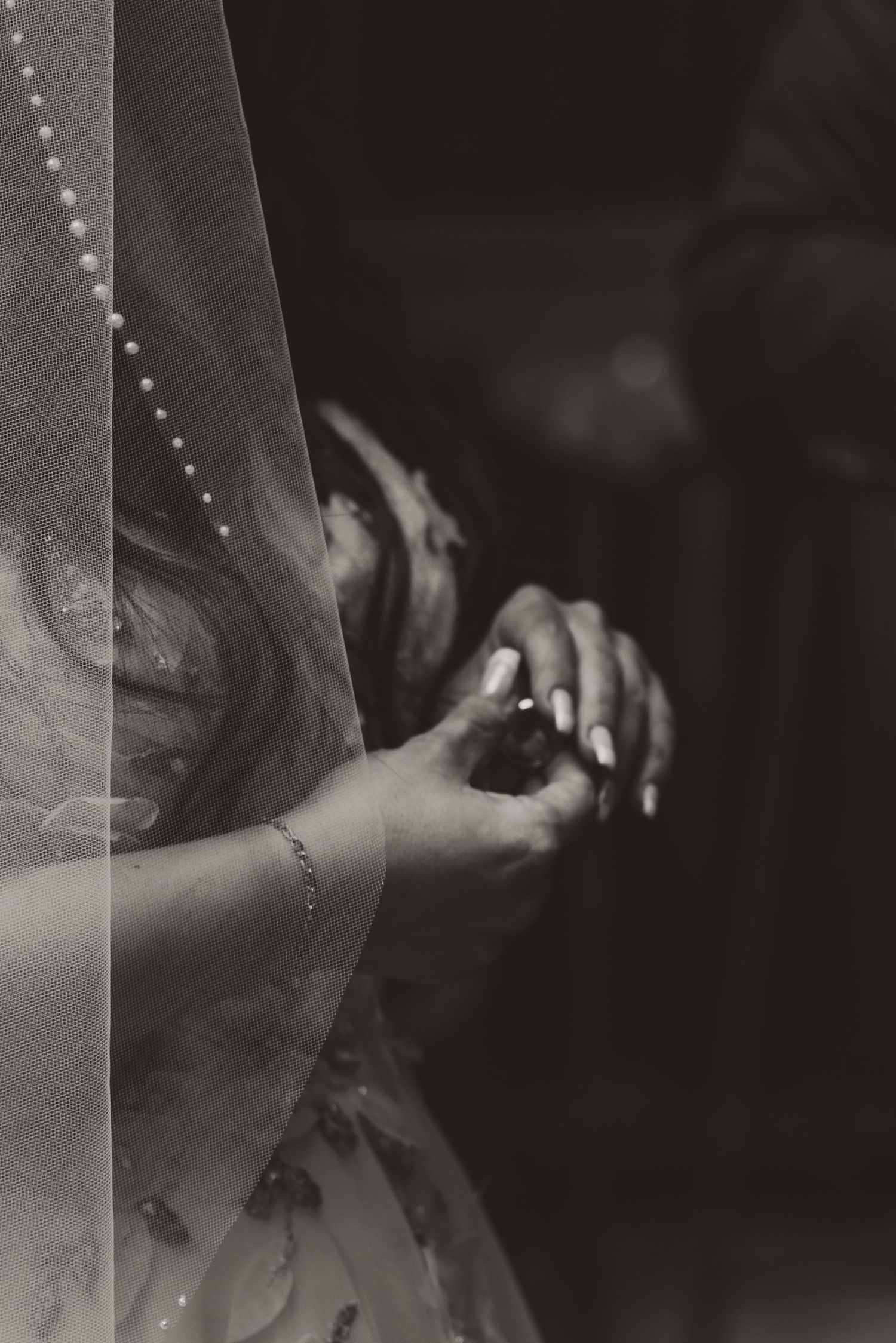 Black and white close-up photograph showing a passionate dance movement with dramatic shadows and lighting effects.