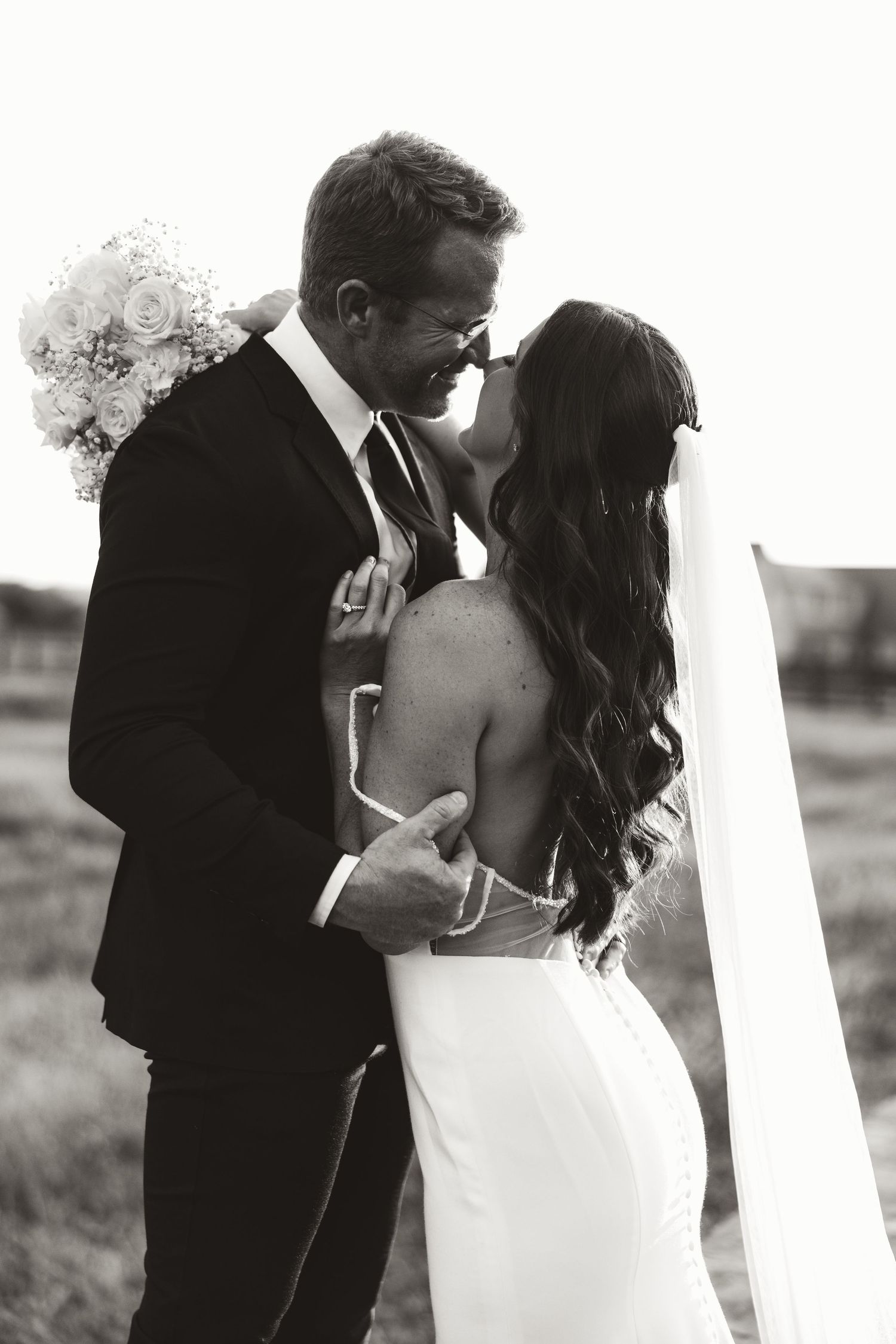 Romantic black and white wedding portraits capturing tender moments between newlyweds.