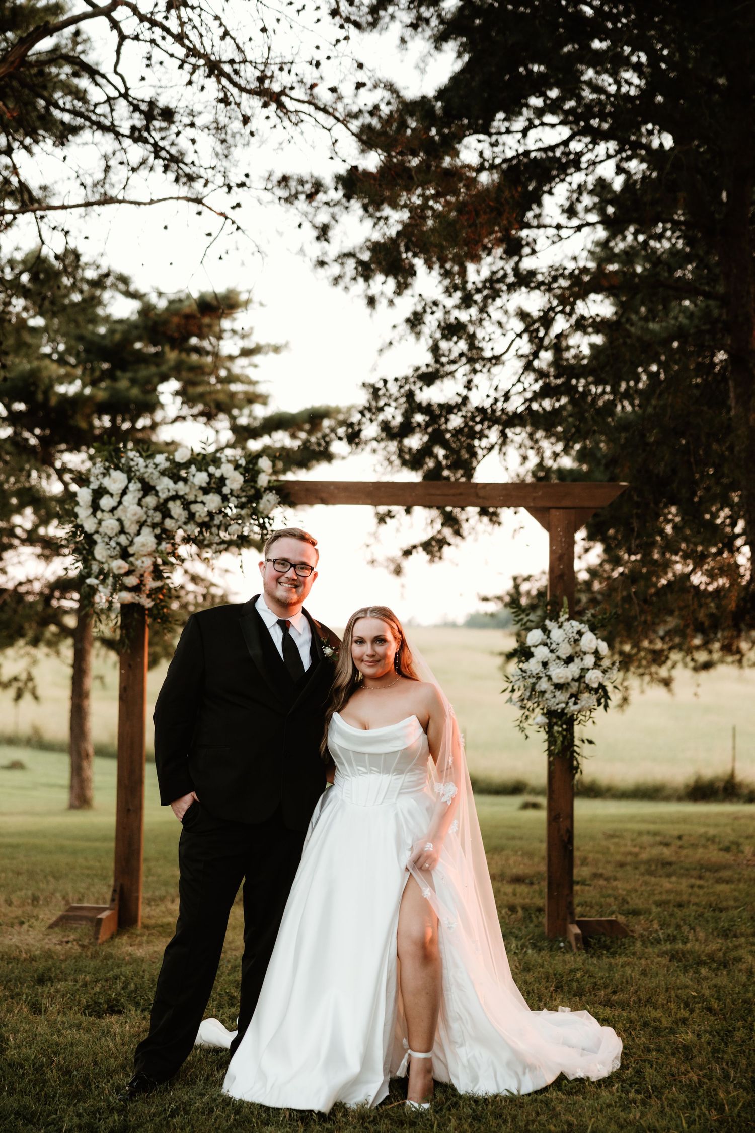 A romantic outdoor wedding scene shows three intimate moments between newlyweds under trees at sunset.