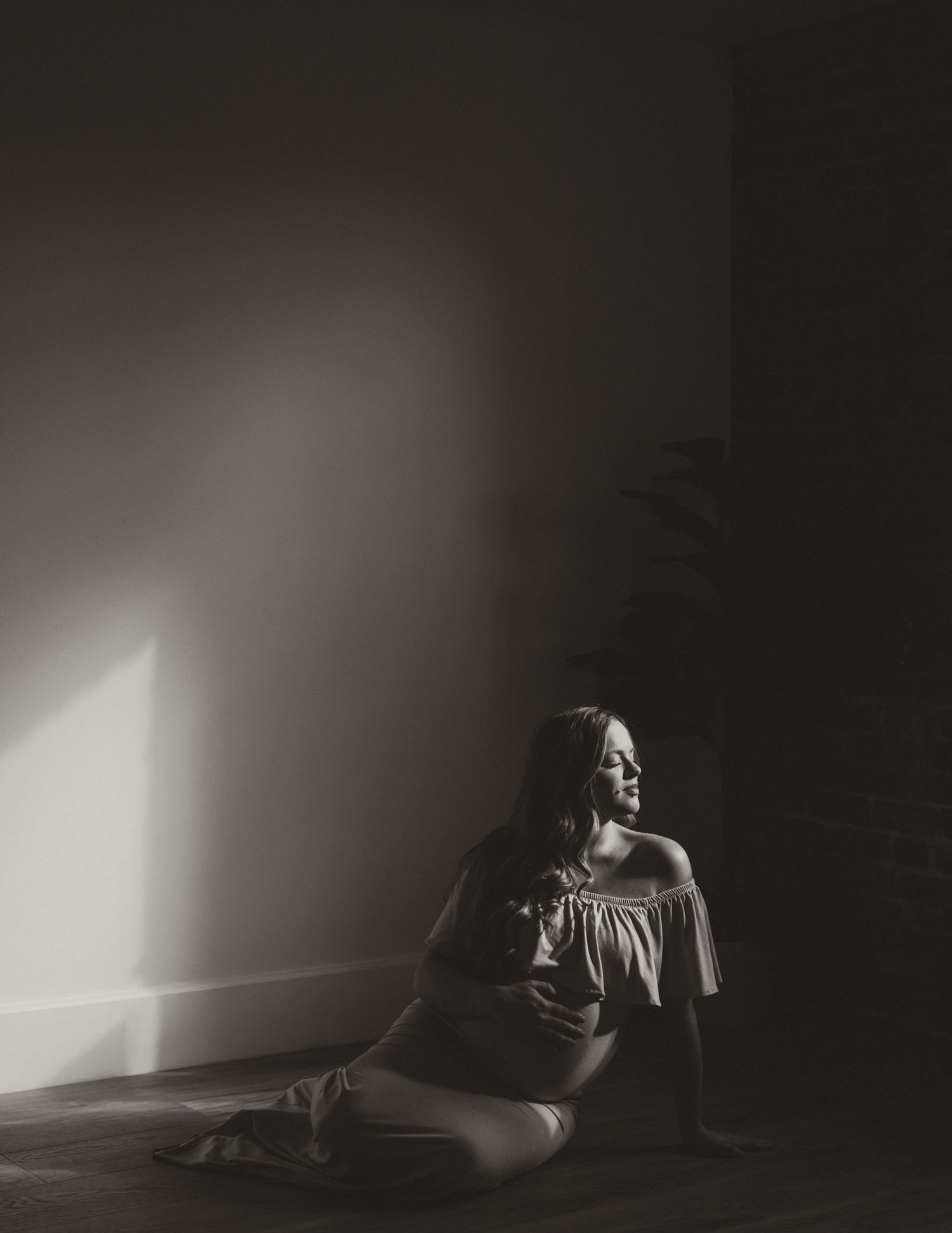 Series of black and white images showing a person resting in shadow against a stark wall with dramatic lighting.