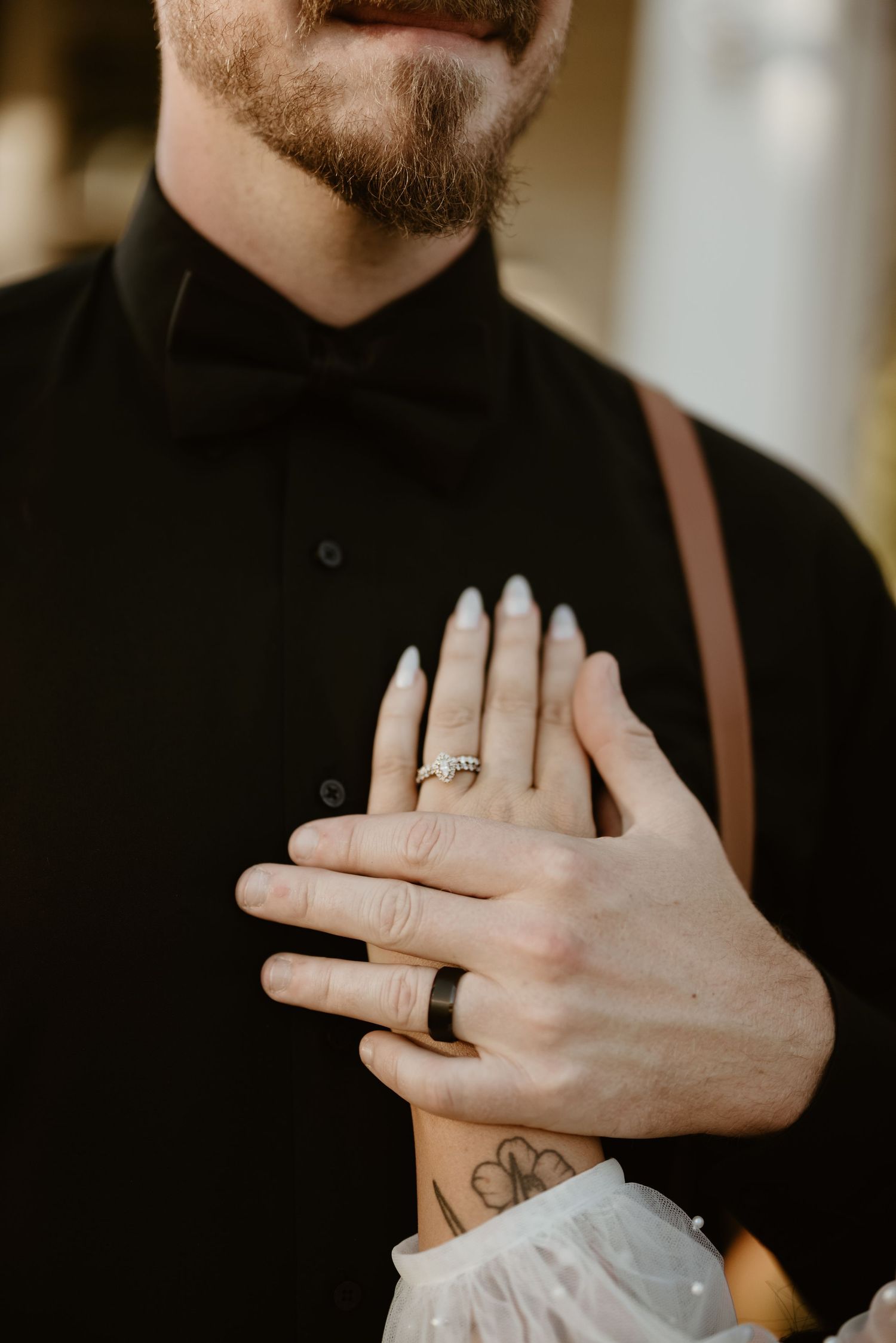 A close-up sequence of hands wearing a wedding ring, showcasing different angles and positions against a dark background.