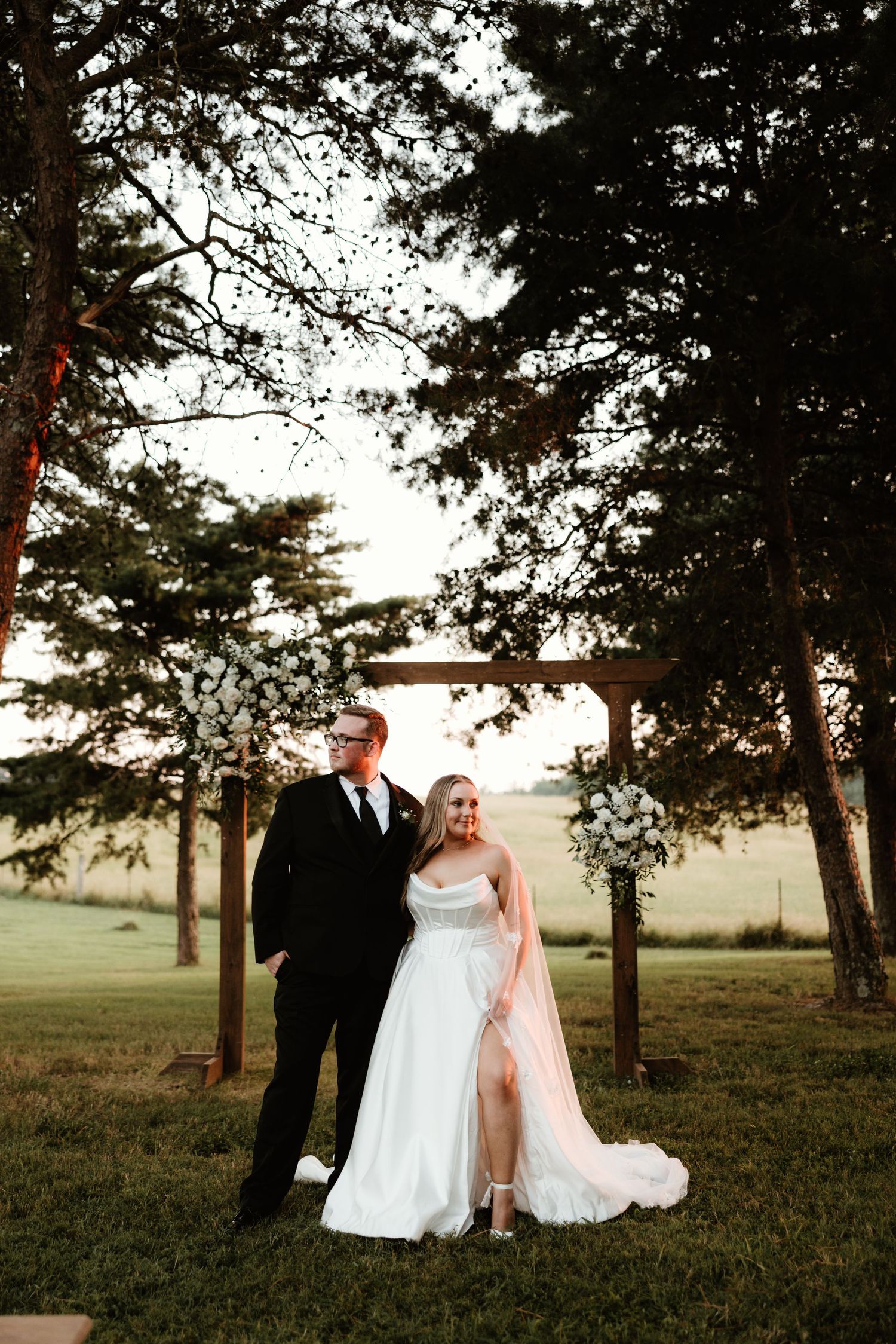 A romantic wedding photoshoot series in a rustic outdoor setting with tall pine trees at sunset.
