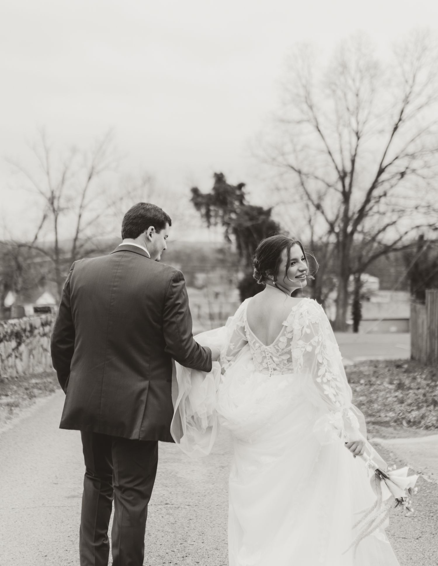 Black and white wedding scene showing a tender first look moment.