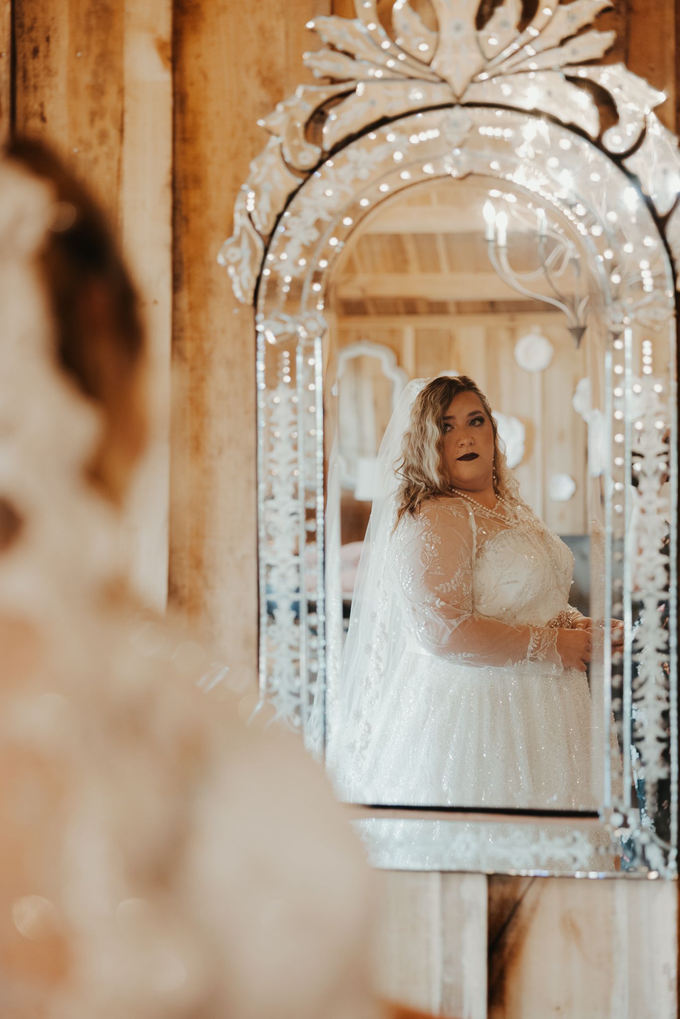 A dreamy wedding scene with a luminous archway decorated in white lights and gossamer fabric creating an ethereal atmosphere.