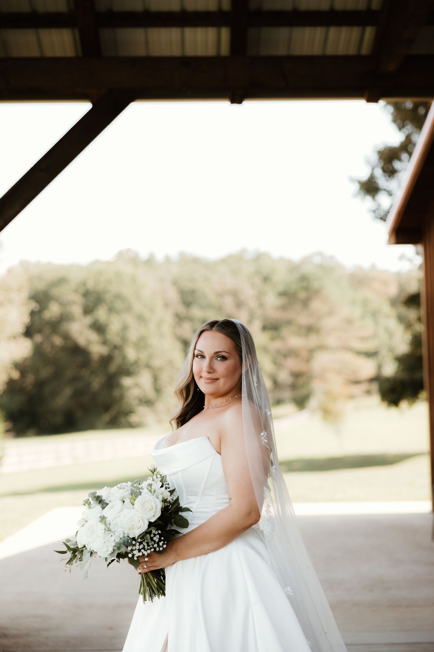 A series of bridal portraits showing different poses in a white wedding dress and veil with a bouquet against a rustic backdrop.