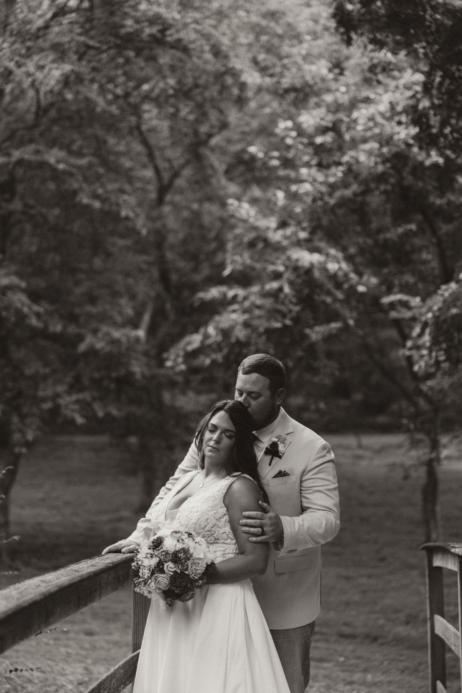 Black and white portrait moment captured during outdoor wedding celebration.