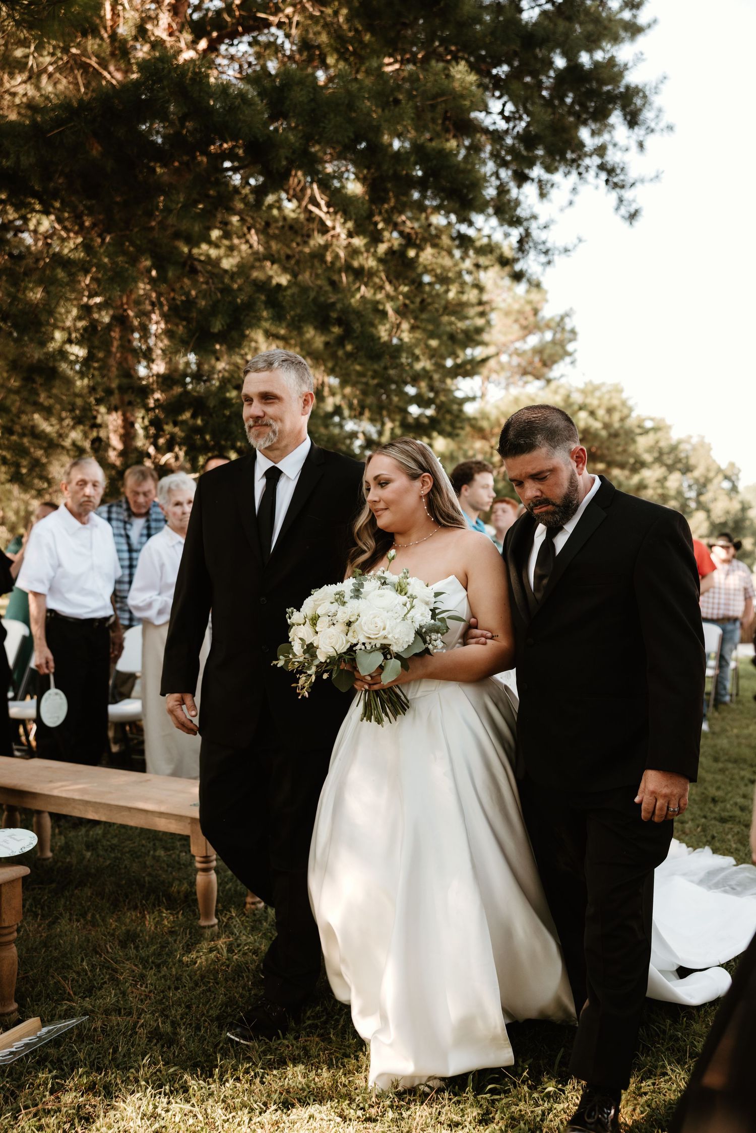 Romantic candid moments captured of bride and groom walking together outdoors at sunset for their wedding photos.