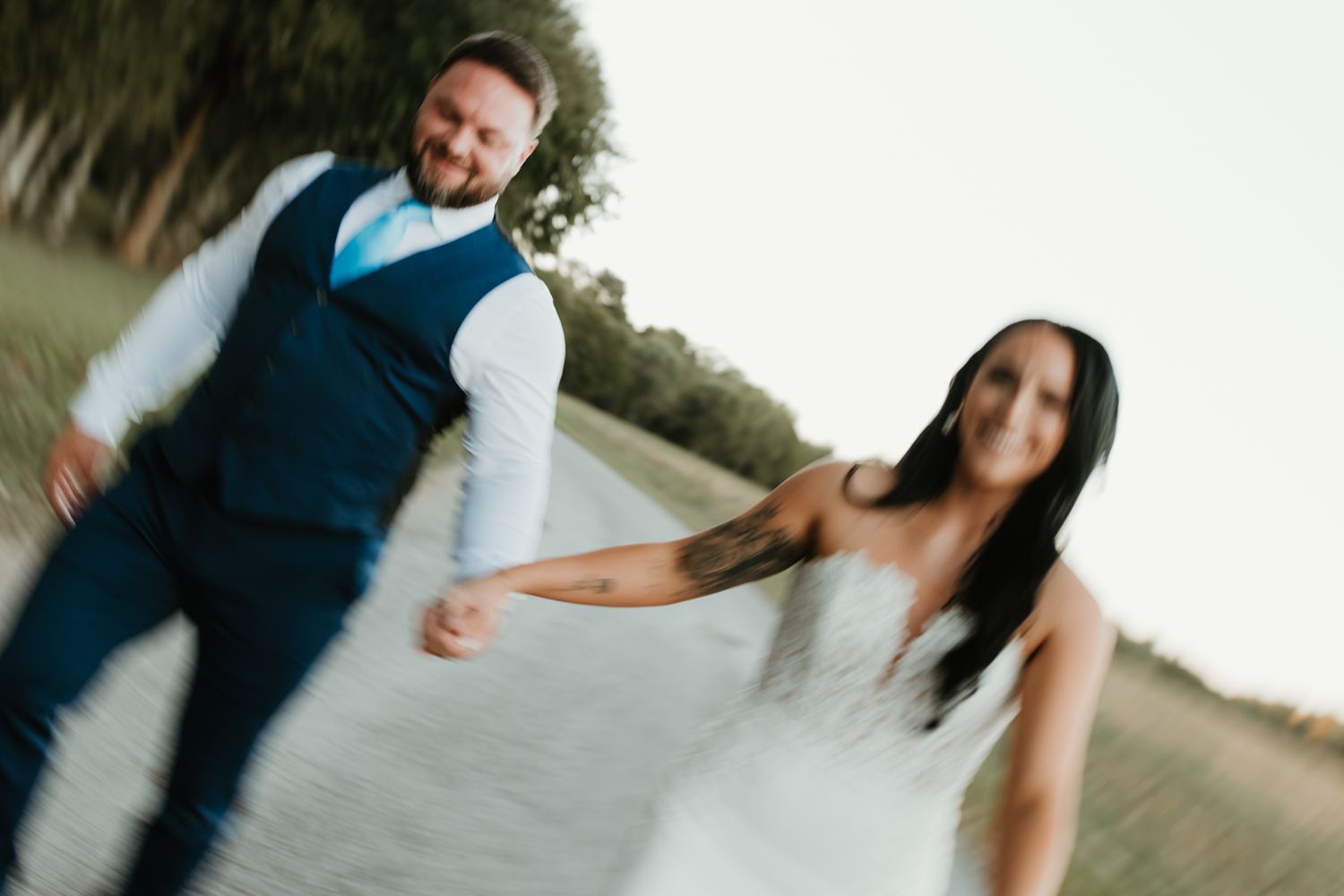 Motion-blurred outdoor wedding photos capturing candid moments between the wedding couple.