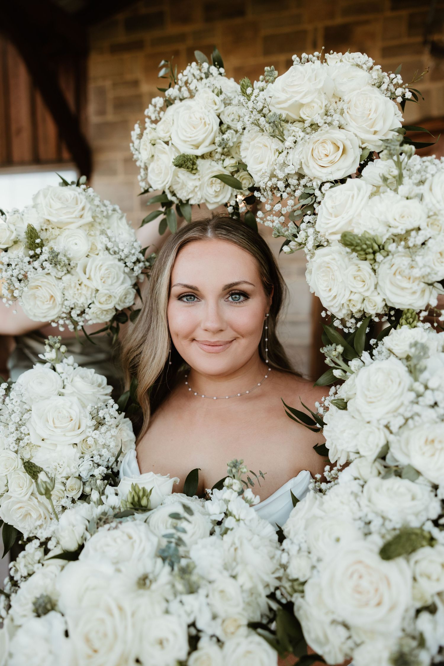 Beautiful white roses and delicate baby's breath flowers arranged in a stunning bridal bouquet display.